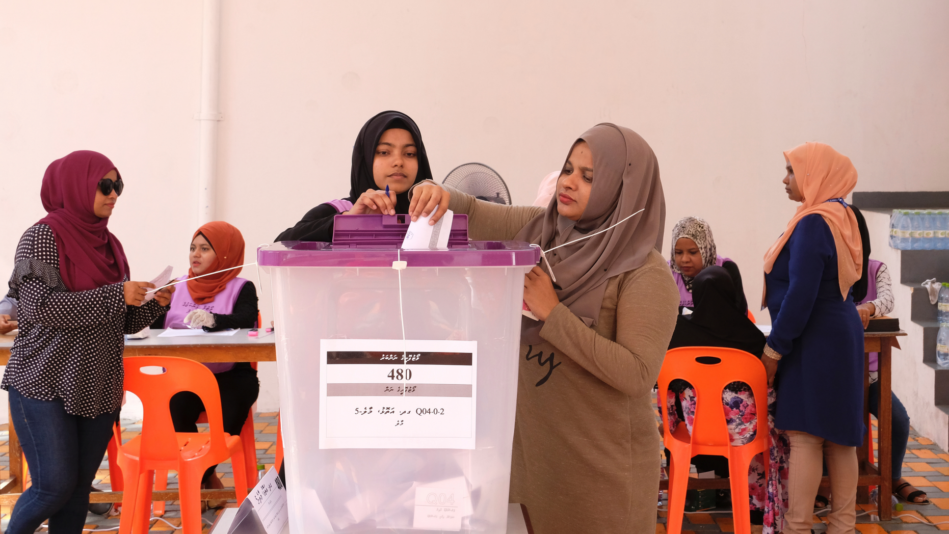 Madivian women cast their votes in Male, Maldives, Saturday, April 6, 2019. Voting is underway in the Maldives in a parliamentary election many hope would help President Ibrahim Mohammed Solih to overcome a coalition split that has hampered his efforts to restore political freedoms and tackle corruption. (AP Photo/Mohamed Sharuhaan)
