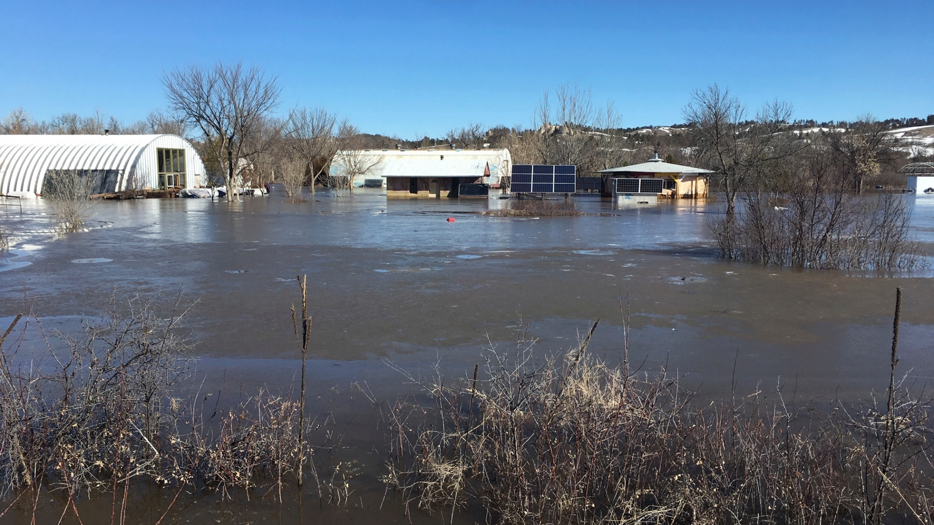In this undated March 2019 photo provided by Henry Red Cloud, shows flooding on Cloud's Lakota Solar Enterprises property on the Pine Ridge Reservation in southern South Dakota. Red Cloud estimates flood damage at $250,000. Plains and Midwest states are bracing for another massive winter storm Wednesday and Thursday and the prospect of renewed flooding when the snow melts. (Henry Red Cloud via AP)