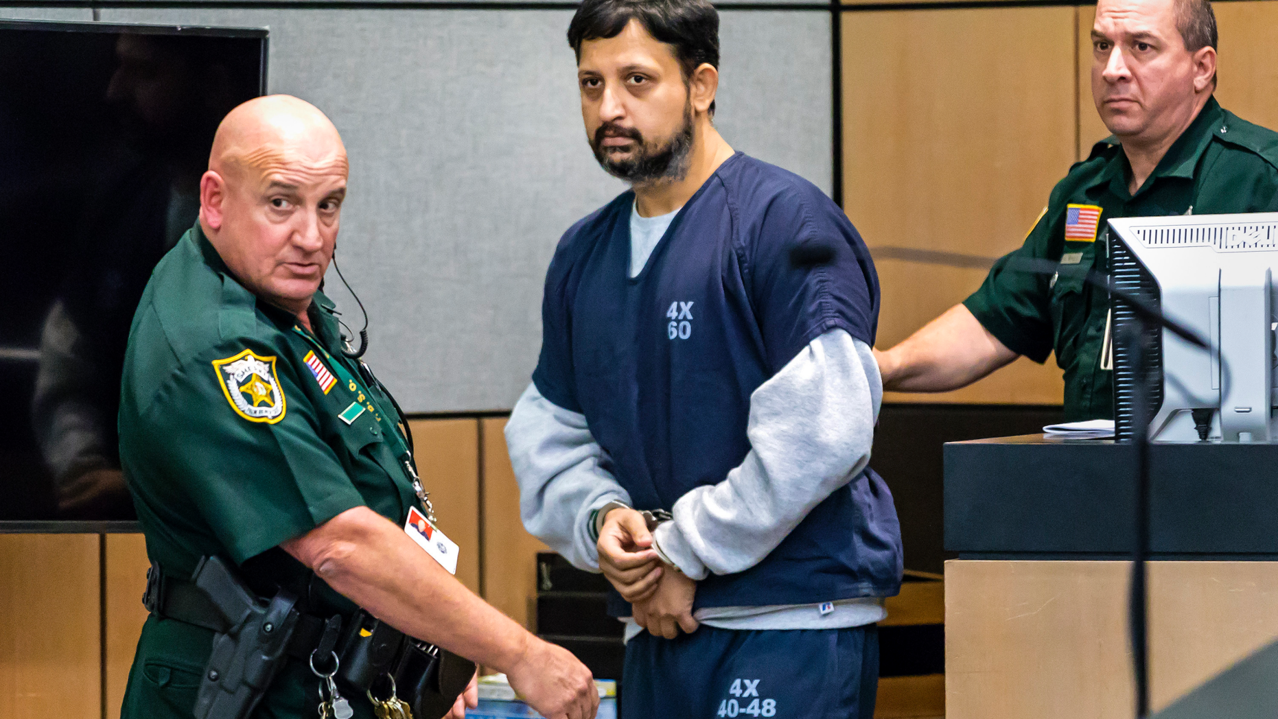 Nouman Raja is brought into the courtroom for sentencing Thursday, April 25, 2019 in West Palm Beach, Fla. Raja, a former Palm Beach Gardens police officer, was convicted on one count each of manslaughter by culpable negligence and first-degree attempted murder. He shot and killed stranded motorist Corey Jones Oct. 18, 2015. (Lannis Waters/Palm Beach Post via AP, Pool)