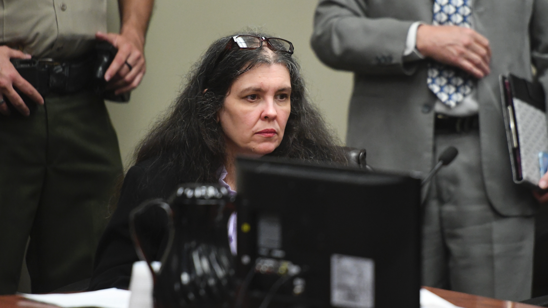 Louise Turpin sits in a courtroom during a sentencing hearing Friday, April 19, 2019, in Riverside, Calif. Turpin and her husband, David, who pleaded guilty to years of torture and abuse of 12 of their 13 children have been sentenced to life in prison with possibility of parole after 25 years. (Will Lester/The Orange County Register via AP, Pool)