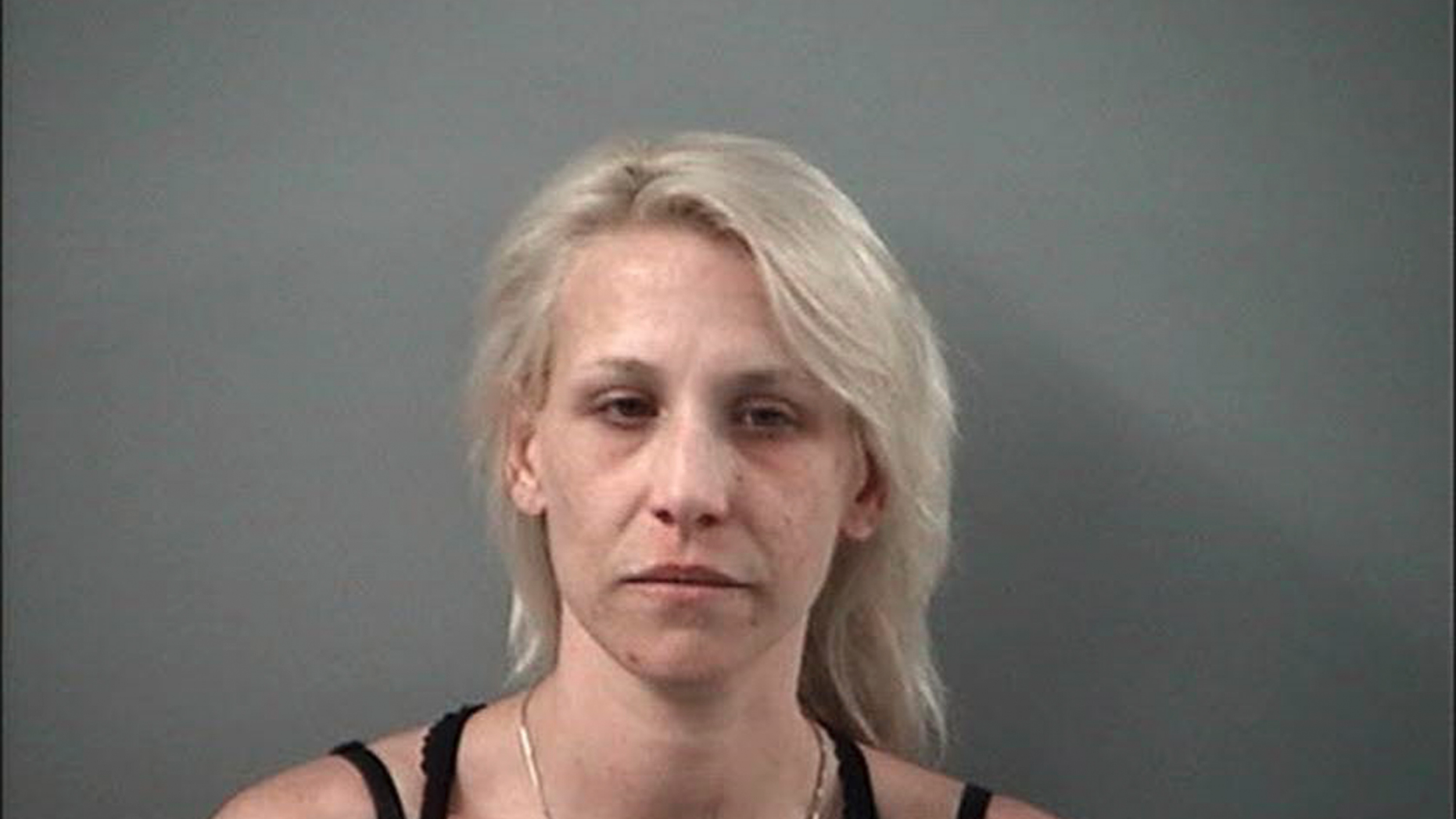 In this April 24, 2019 booking photo provided by the Crystal Lake Police Department of Joann Cunningham who along with her husband Andrew Freund Sr. have been charged with murder and other charges in the death of their missing son Andrew "AJ" Freund. Authorities say they have found what they believe is the body of the 5-year-old boy who went missing last week. Crystal Lake police Chief James Black said at a news conference Wednesday that police dug up what they believe is Freund's body in a field and that it was wrapped in plastic. (Crystal Lake Police Department via AP)