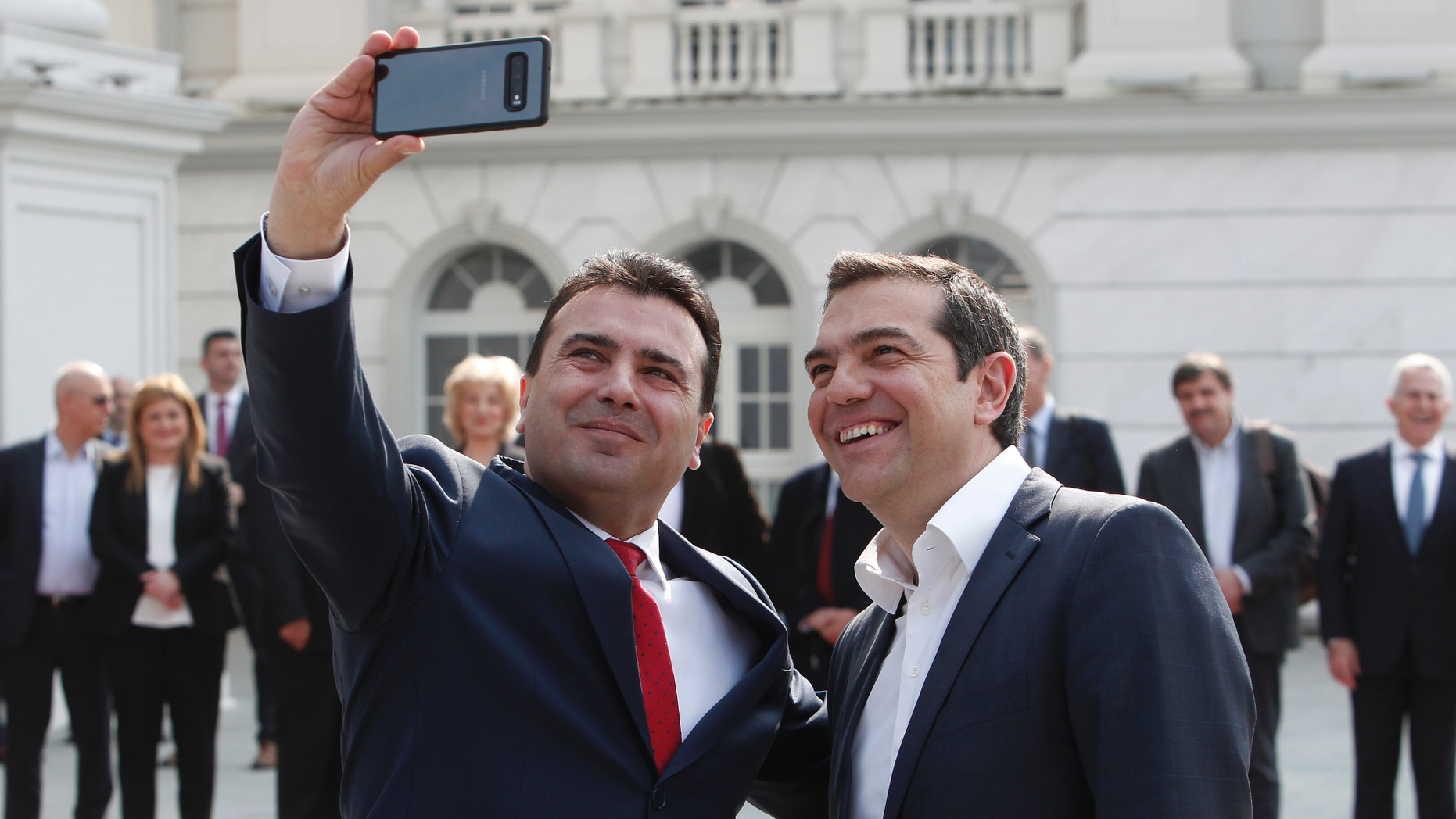North Macedonia Prime Minister Zoran Zaev, left, takes a selfie with his Greek counterpart Alexis Tsipras, outside the Prime Minister office in Skopje, North Macedonia, on Tuesday, April 2, 2019. Greek Prime minister has arrived in North Macedonia, the first ever official visit of a Greek leader to neighboring country after decades of strained relations between two nations burdened over the name "Macedonia".(AP Photo/Boris Grdanoski)