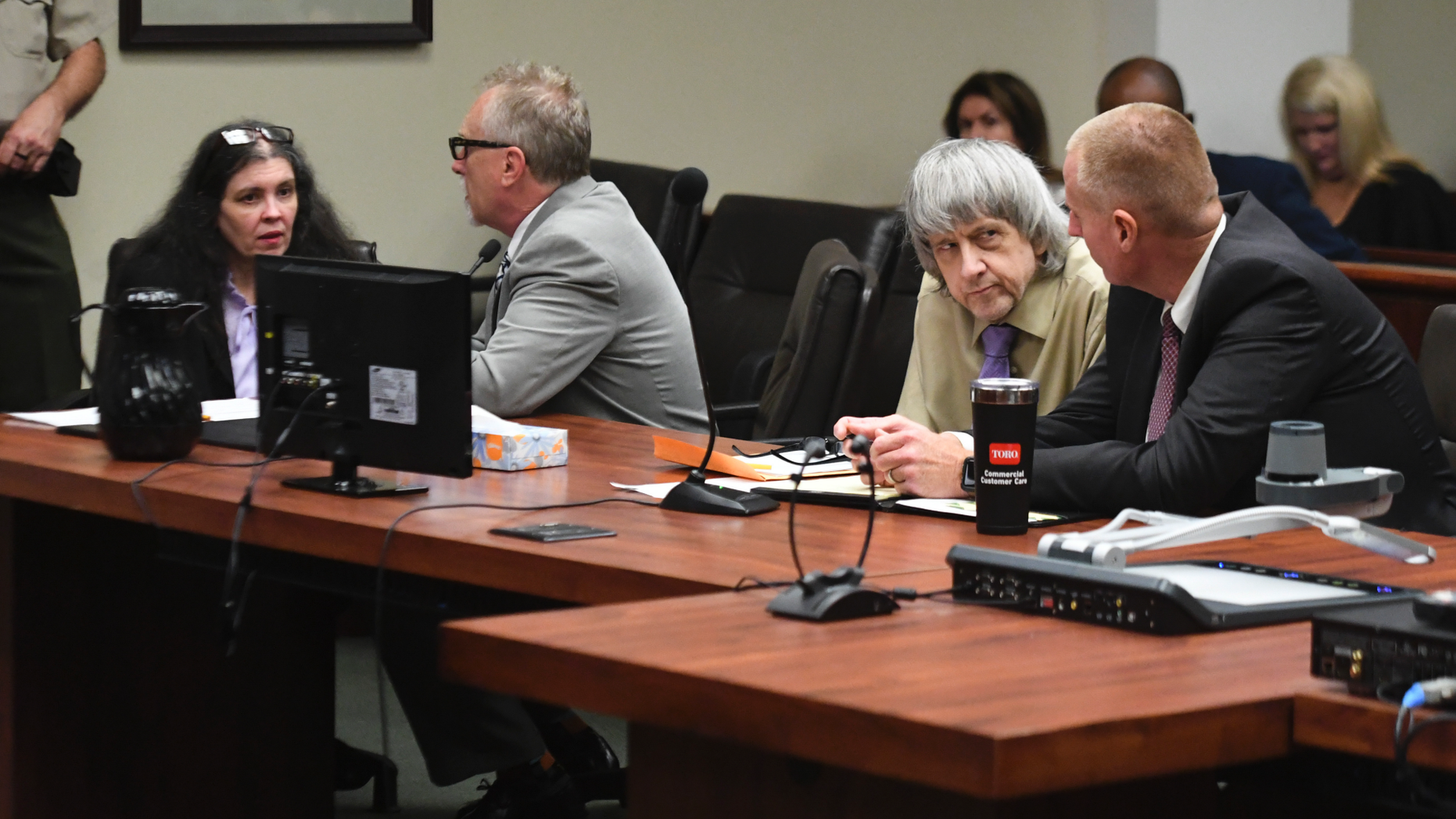 David Turpin, second from right, and wife, Louise, left, talk to their attorneys during a sentencing hearing Friday, April 19, 2019, in Riverside, Calif. The California couple who pleaded guilty to years of torture and abuse of 12 of their 13 children have been sentenced to life in prison with possibility of parole after 25 years. (Will Lester/The Orange County Register via AP, Pool)