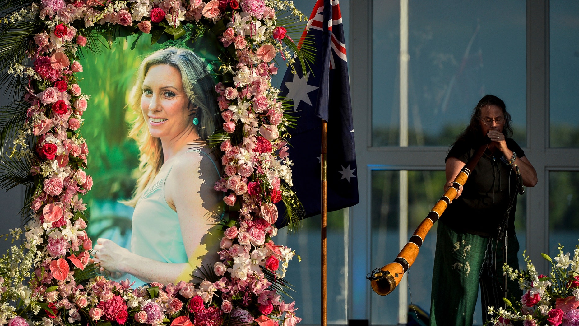 Johanna Morrow plays the didgeridoo during a memorial service for Justine Ruszczyk Damond at Lake Harriet in Minneapolis. Jury selection is scheduled to begin Monday