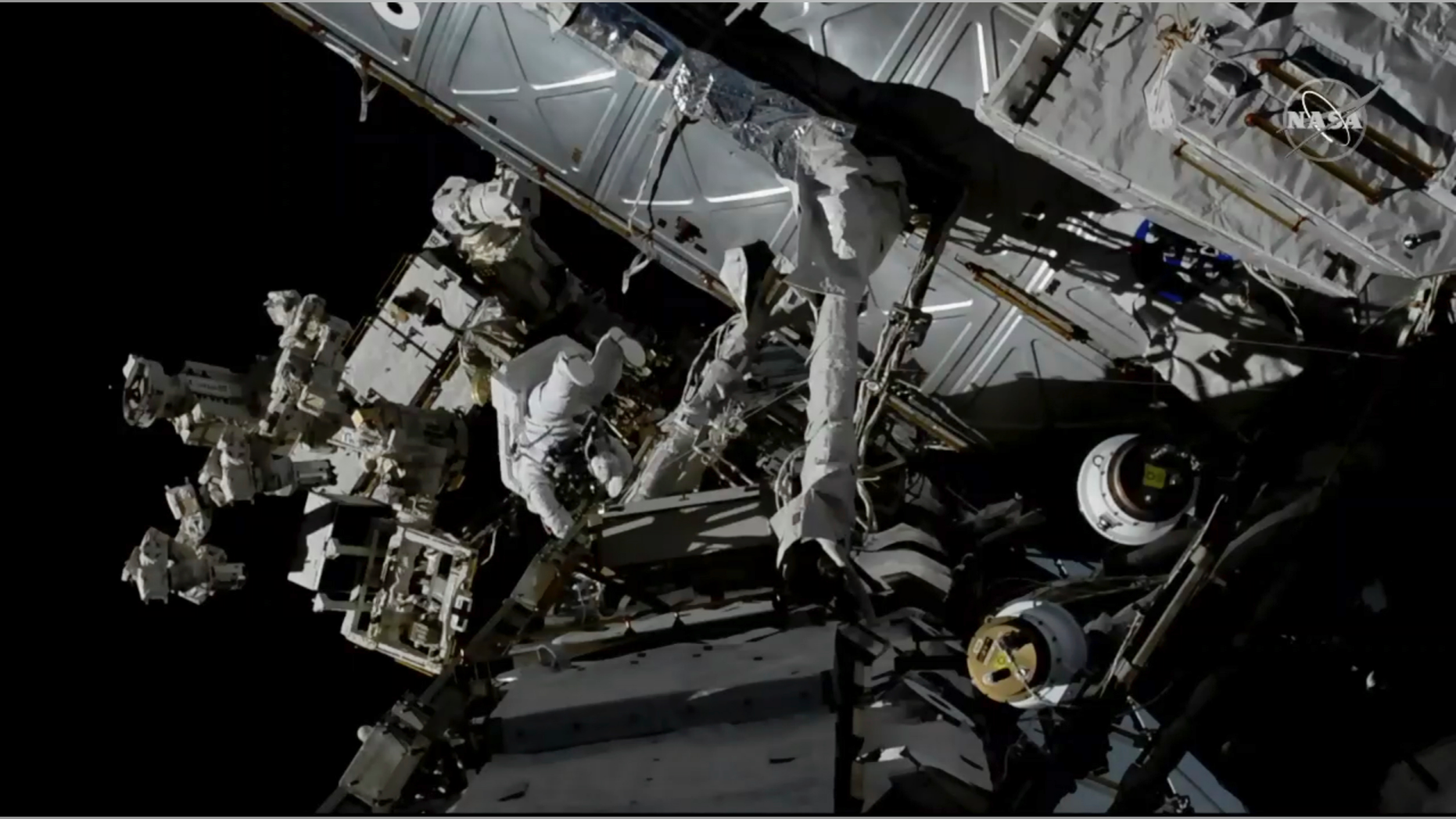 In this photo provided by NASA, Canadian astronaut David Saint-Jacques, center left, works outside the International Space Station, Monday, April 8, 2019. (NASA via AP)