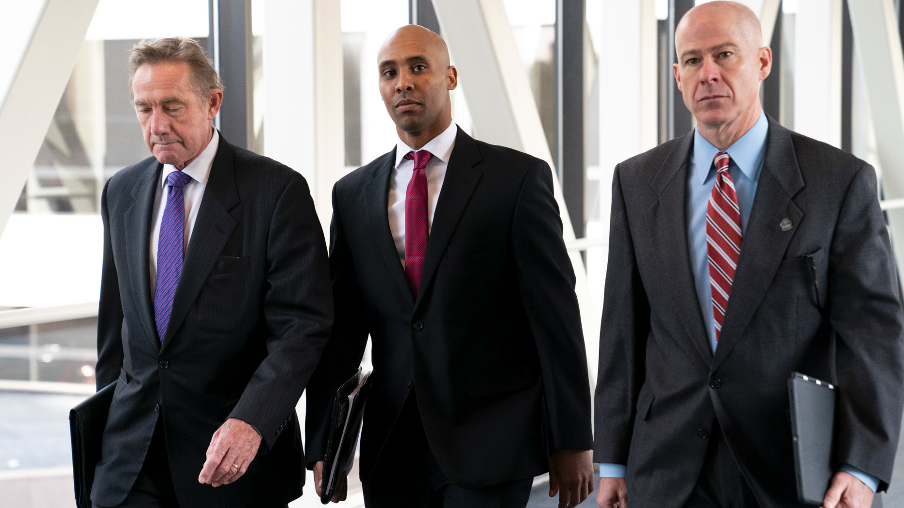 Former Minneapolis police officer Mohamed Noor, center, arrives for the first day of jury selection with his attorneys Peter Wold, left, and Thomas Plunkett, at the Hennepin County Government Center in Minneapolis, Minn., on Monday, April 1, 2019. (Renee Jones Schneider/Star Tribune via AP)