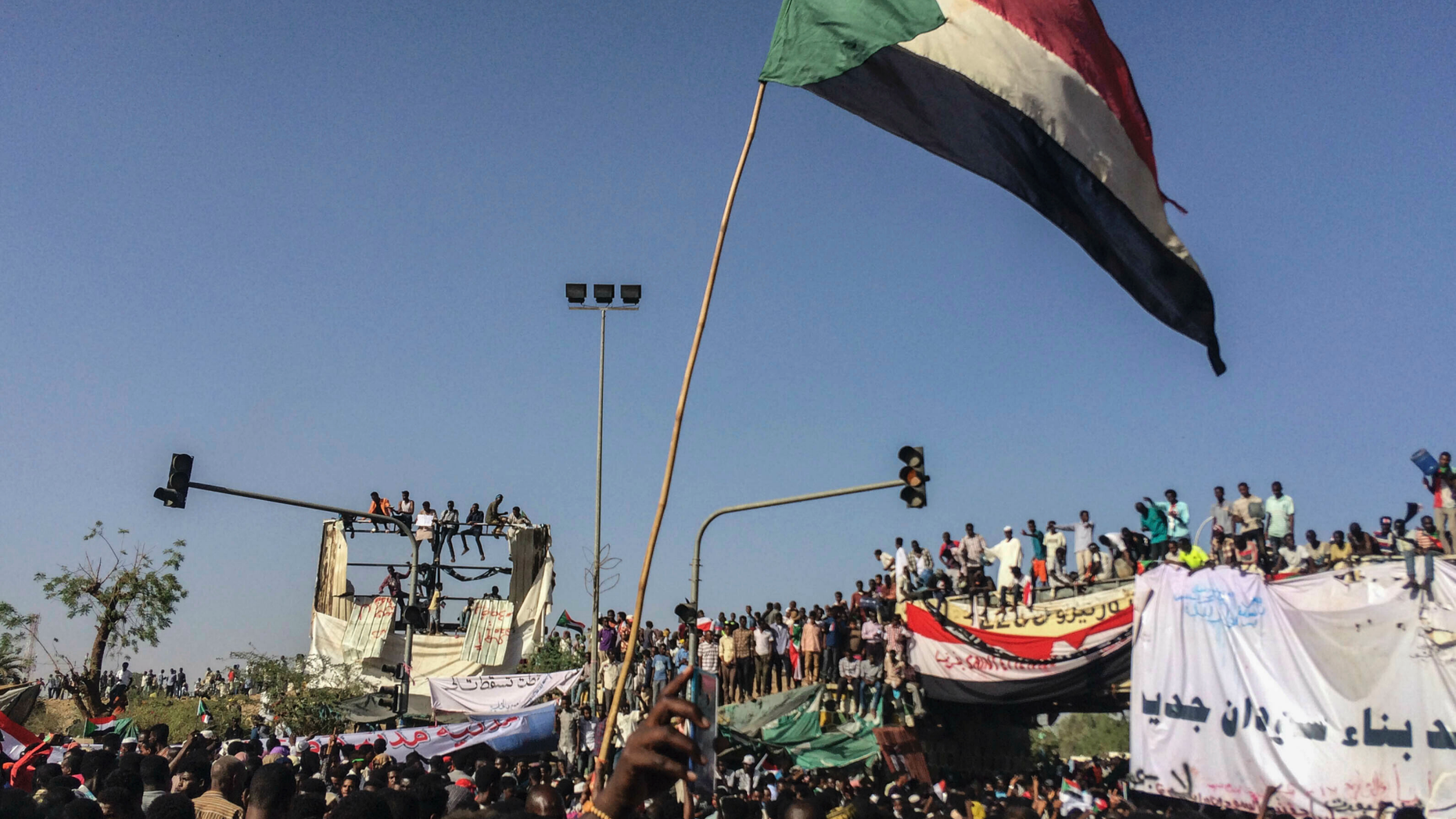 Sudanese demonstrators march with national flags as they gather during a rally demanding a civilian body to lead the transition to democracy, outside the army headquarters in the Sudanese capital Khartoum on Saturday, April 13, 2019. The military overthrew President Omar al-Bashir on Thursday after almost four months of protests calling for an end to his nearly 30-year rule. (AP Photo)