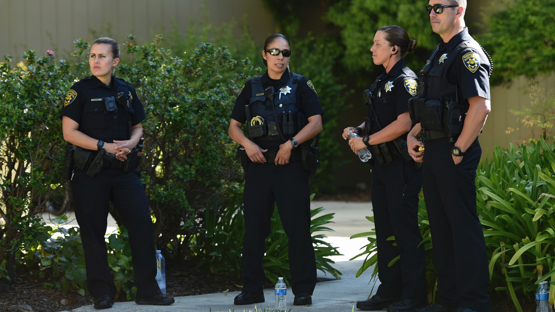 Police stand outside an apartment complex believed to be associated with a car crash suspect in Sunnyvale, Calif., on Wednesday, April 24, 2019. Investigators are working to determine the cause of the crash in Northern California that injured several pedestrians on Tuesday evening. Authorities say the driver of the car was taken into custody after he appeared to deliberately plow into the group. (AP Photo/Cody Glenn)