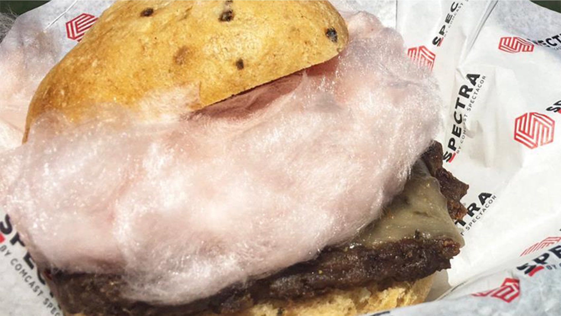The burger includes a green chili bun, grilled Angus burger, ghost pepper cheese and a large puff of red chili cotton candy.