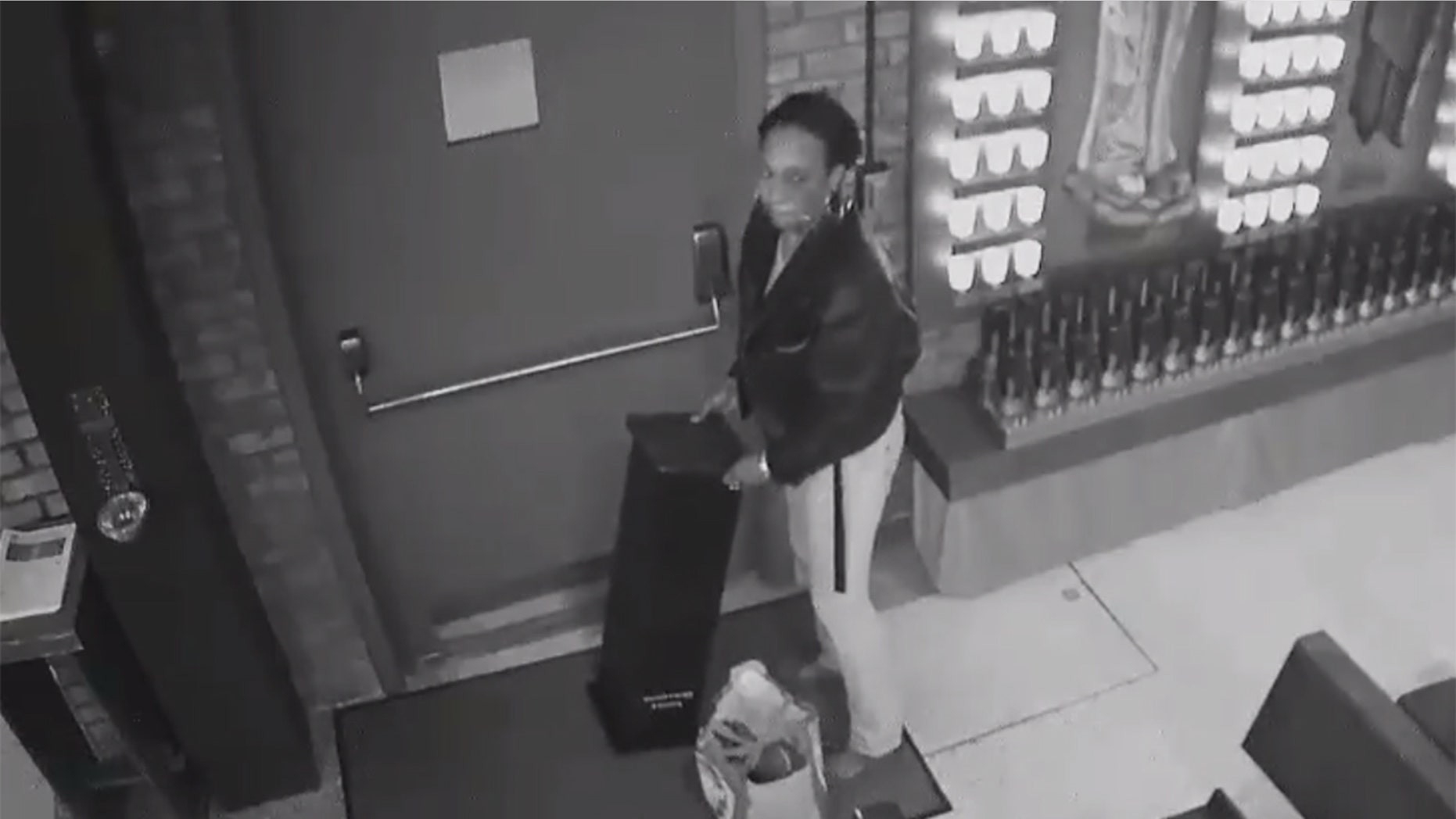 Image taken from surveillance video released by the NYPD showing a woman wanted for pilfering a donation box during a break-in at a parish church in New York last week.