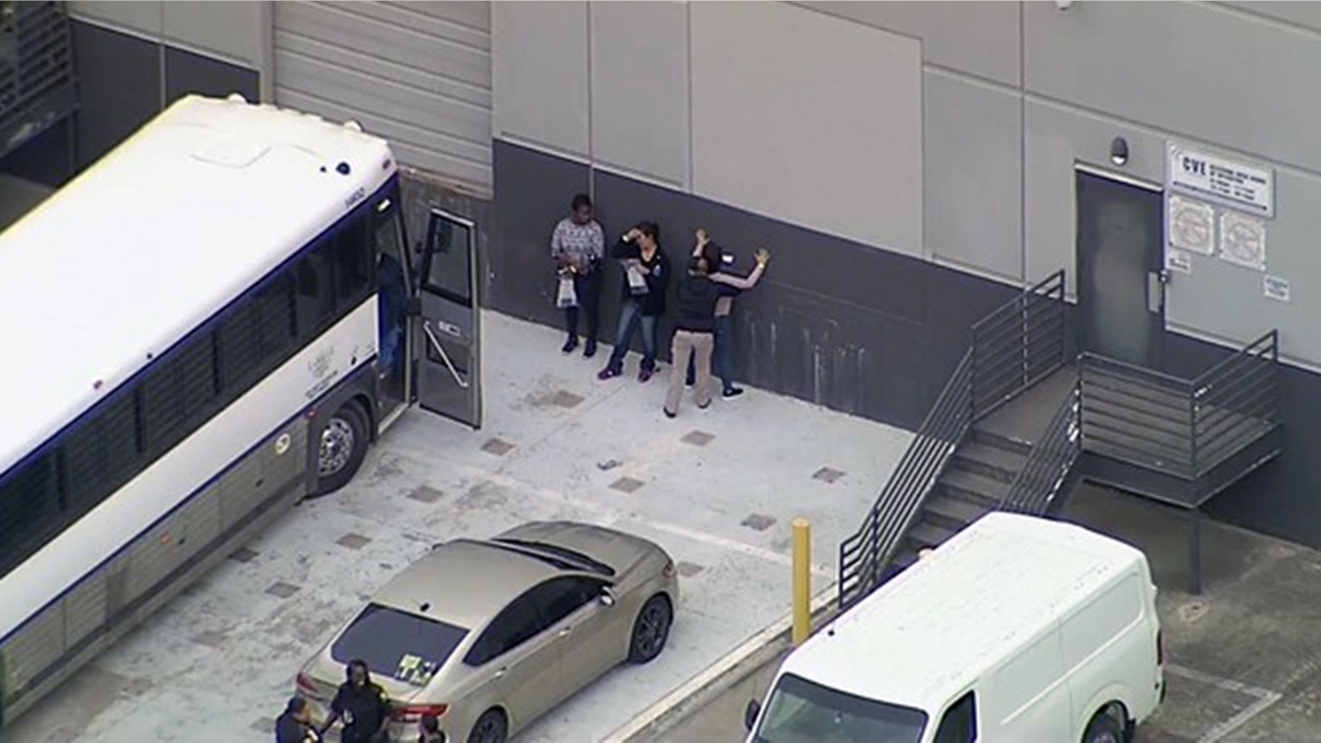 Workers are searched outside CVE Group in Allen, Texas, on Wednesday.