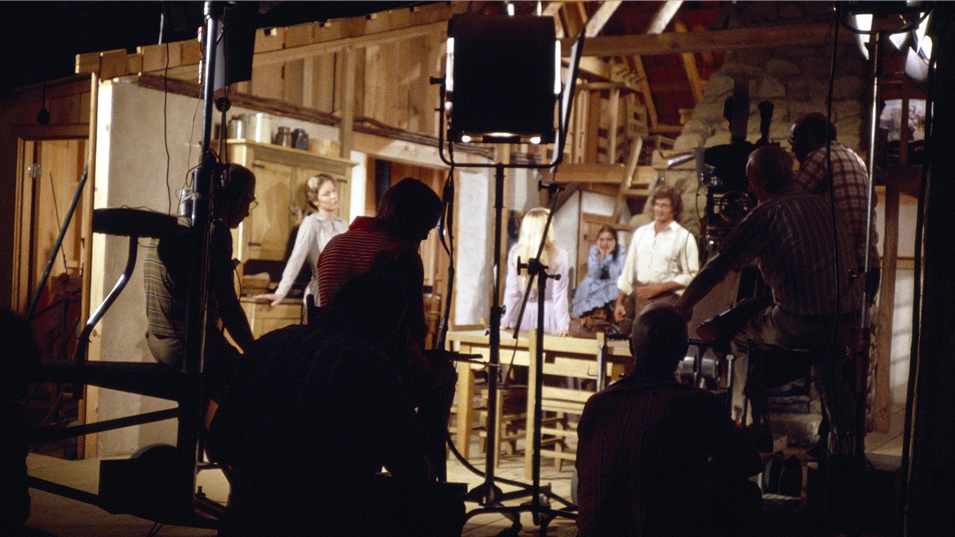 The cast and crew of "Little House on the Prairie" in a studio set.
