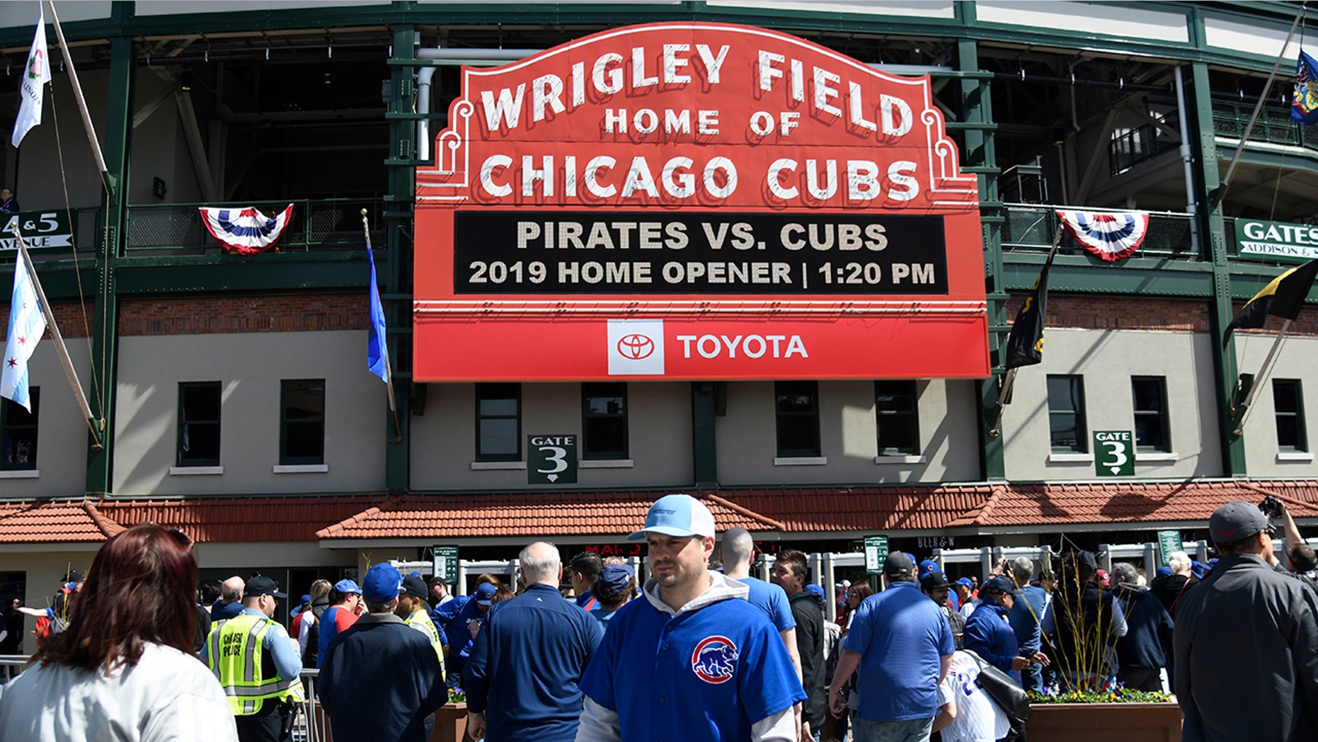 Fans walk around the ballpark before the Chicago Cubs home opening baseball game against the Pittsburgh Pirates, Monday, April 8, 2019, in Chicago.