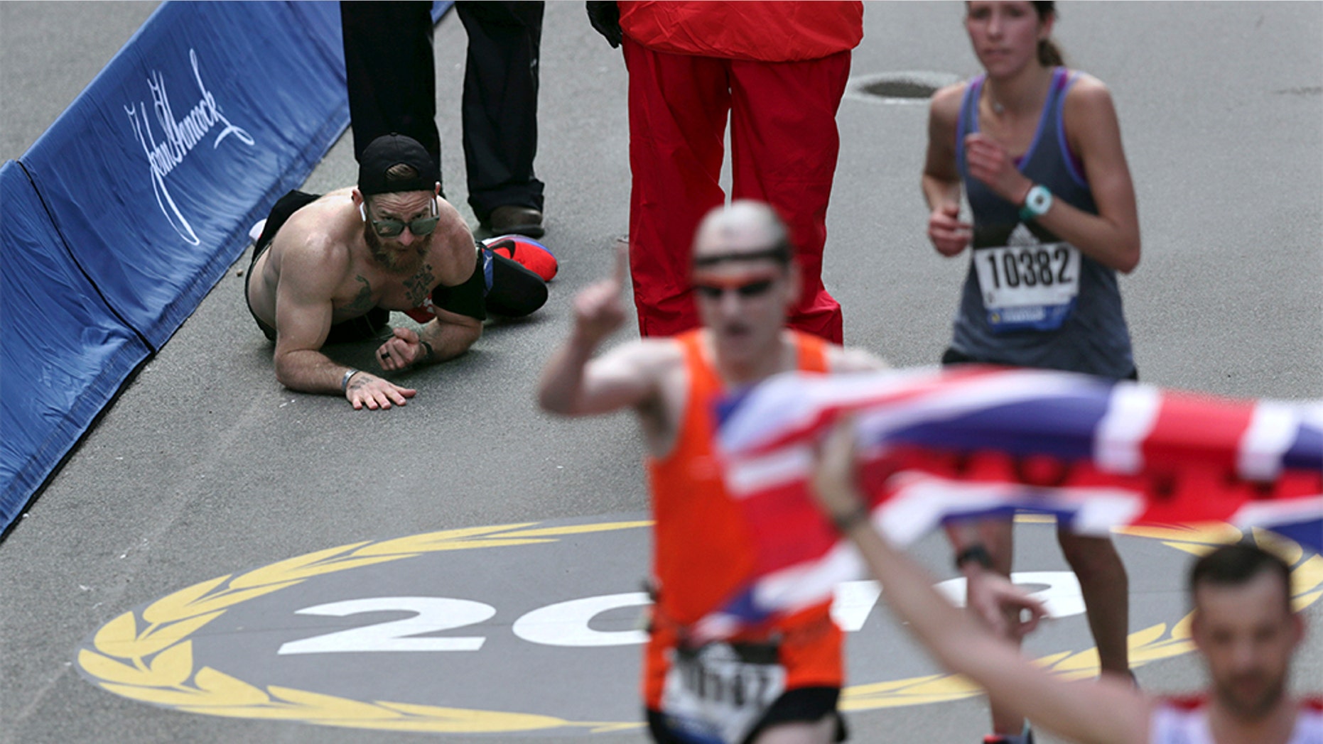 Micah Herndon, a Marine who served in Iraq and Afghanistan, crawled across the finish line of the Boston Maraton on Monday.