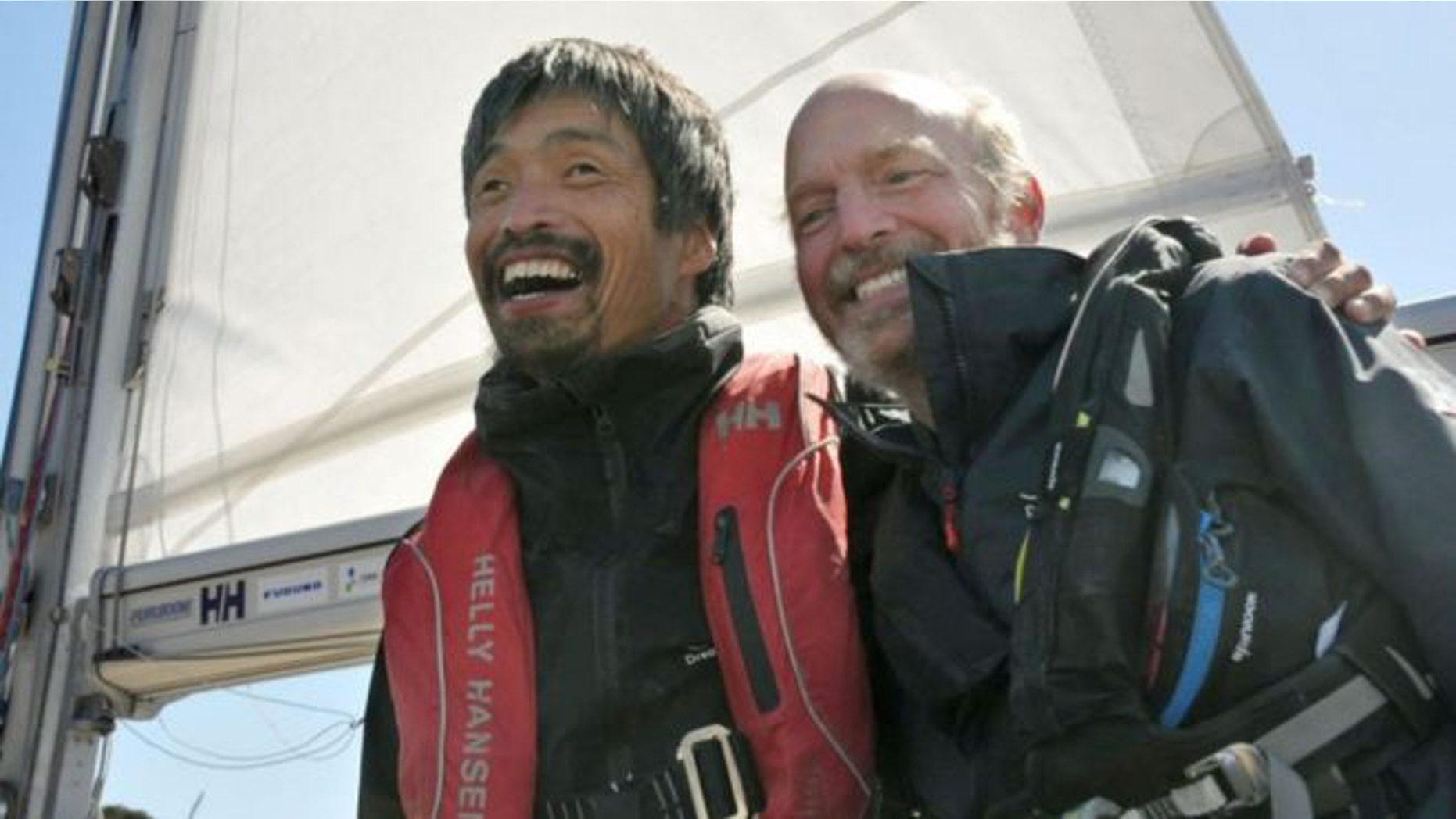 Mitsuhiro Iwamoto, a blind Japanese sailor, celebrates with his navigator Doug Smith of the U.S. after successfully completing a near two-month, non-stop voyage from San Diego to Fukushima Prefecture on the Pacific Ocean, upon their arrival at Onahama port in Iwaki, Fukushima prefecture, Japan, in this photo taken by Kyodo April 20, 2019.
