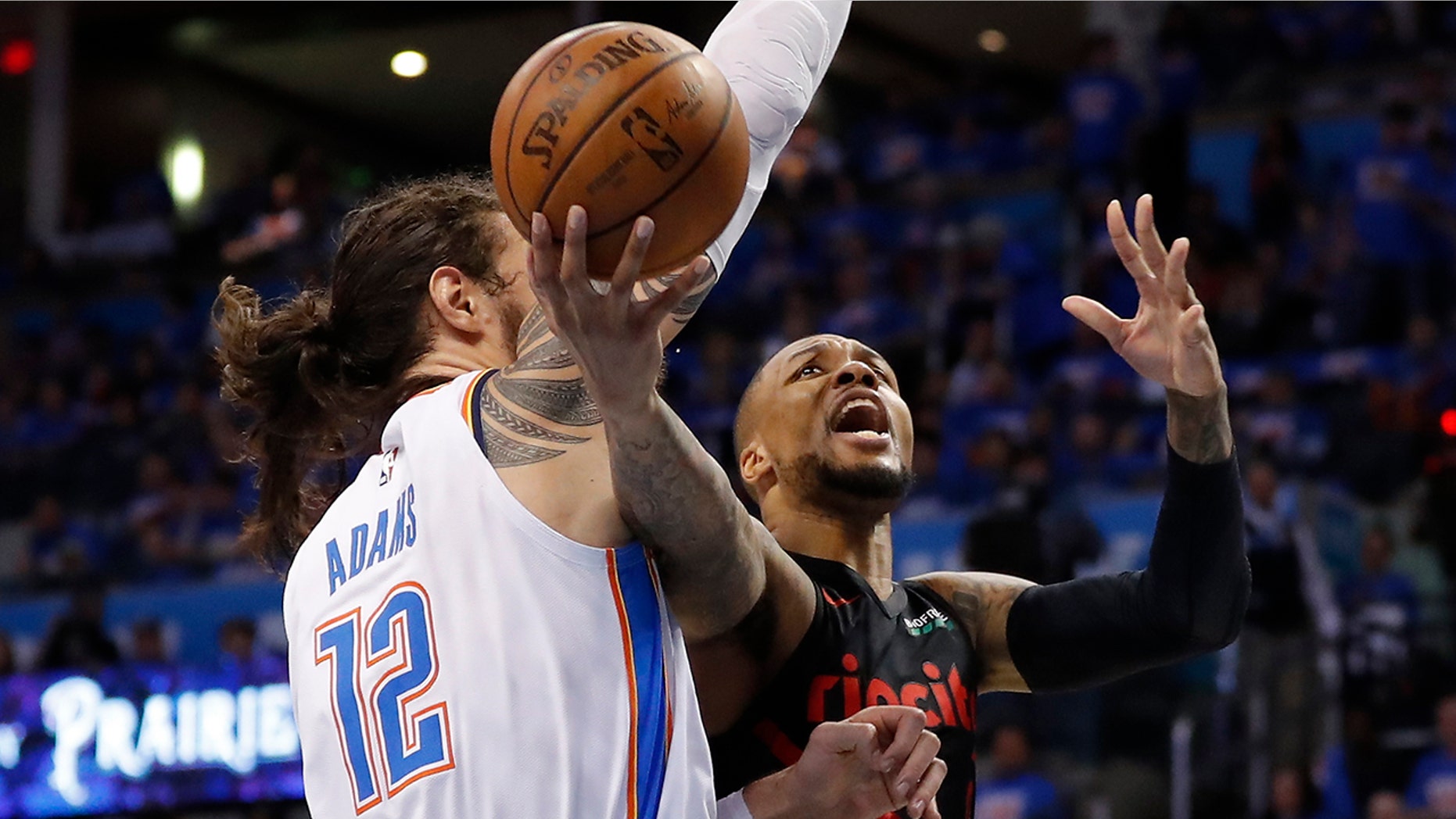 Portland Trail Blazers guard Damian Lillard (0) goes to the basket as Oklahoma City Thunder center Steven Adams (12) defends in the second half of Game 4 of an NBA basketball first-round playoff series Sunday, April 21, 2019, in Oklahoma City. Portland won 111-98. (AP Photo/Alonzo Adams)