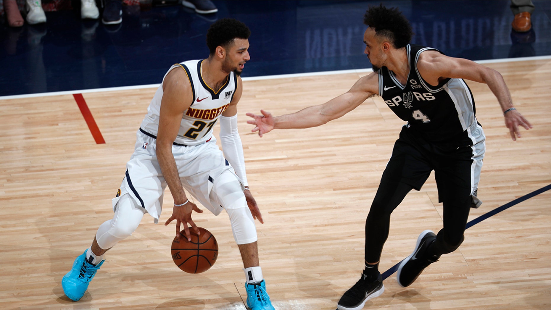Denver Nuggets guard Jamal Murray, left, looks to shoot the ball as San Antonio Spurs guard Derrick White defends in the second half of Game 2 of an NBA basketball playoff series Tuesday, April 16, 2019, in Denver. The Nuggets won 114-105. (AP Photo/David Zalubowski)