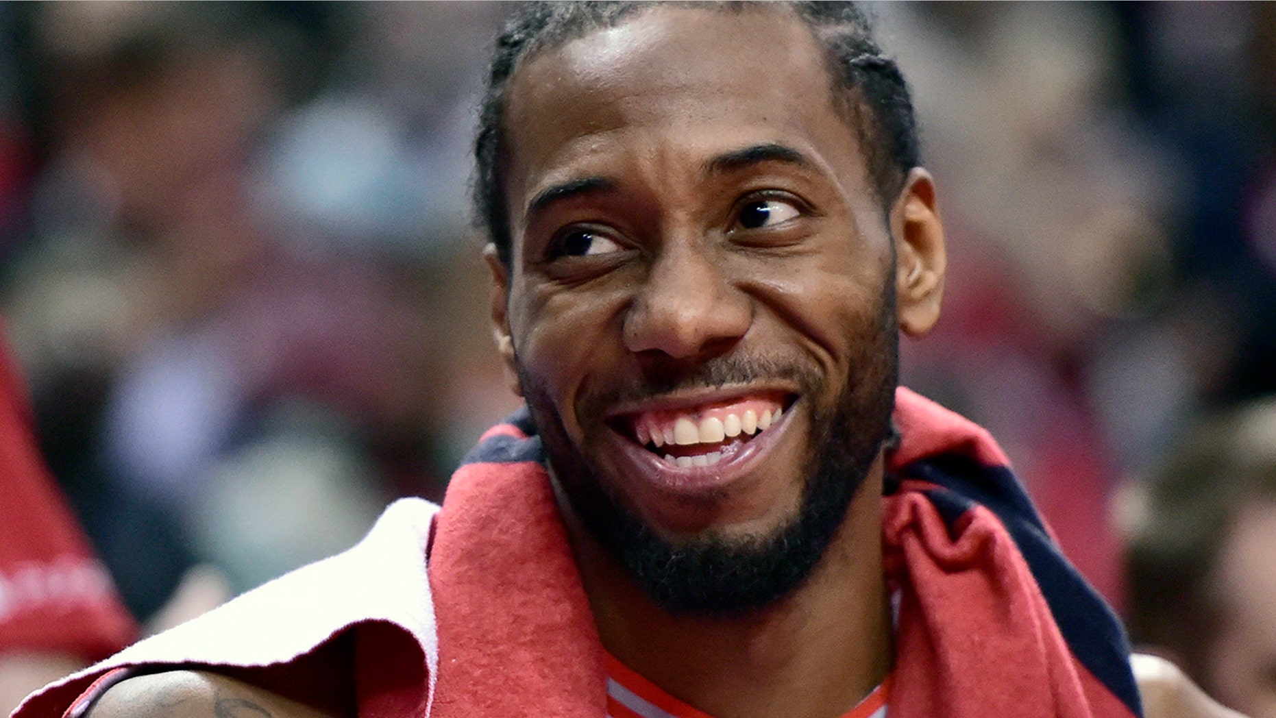 Toronto Raptors forward Kawhi Leonard (2) smiles from the bench during a late second half timeout in Game 5 of a first-round NBA basketball playoff series against the Orlando Magic, Tuesday, April 23, 2019 in Toronto. (Frank Gunn/Canadian Press via AP)