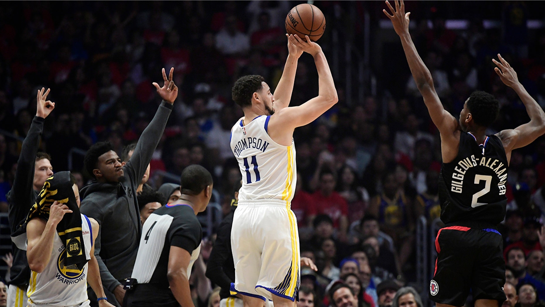 Golden State Warriors guard Klay Thompson, left, shoots as Los Angeles Clippers guard Shai Gilgeous-Alexander defends during the first half in Game 4 of a first-round NBA basketball playoff series Sunday, April 21, 2019, in Los Angeles. (AP Photo/Mark J. Terrill)