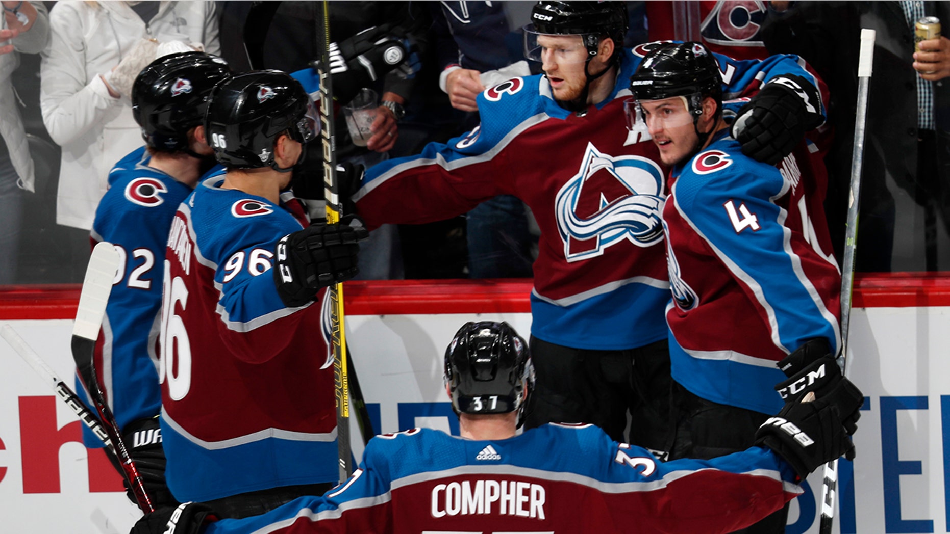 Colorado Avalanche center Nathan MacKinnon, back center, is congratulated after his power-play goal by teammates Gabriel Landeskog, back left, and Mikko Rantanen, front left, J.T. compeer, front, and Tyson Barrie in the first period of Game 3 of a first-round NHL hockey playoff series against the Calgary Flames, Monday, April 15, 2019, in Denver. (AP Photo/David Zalubowski)