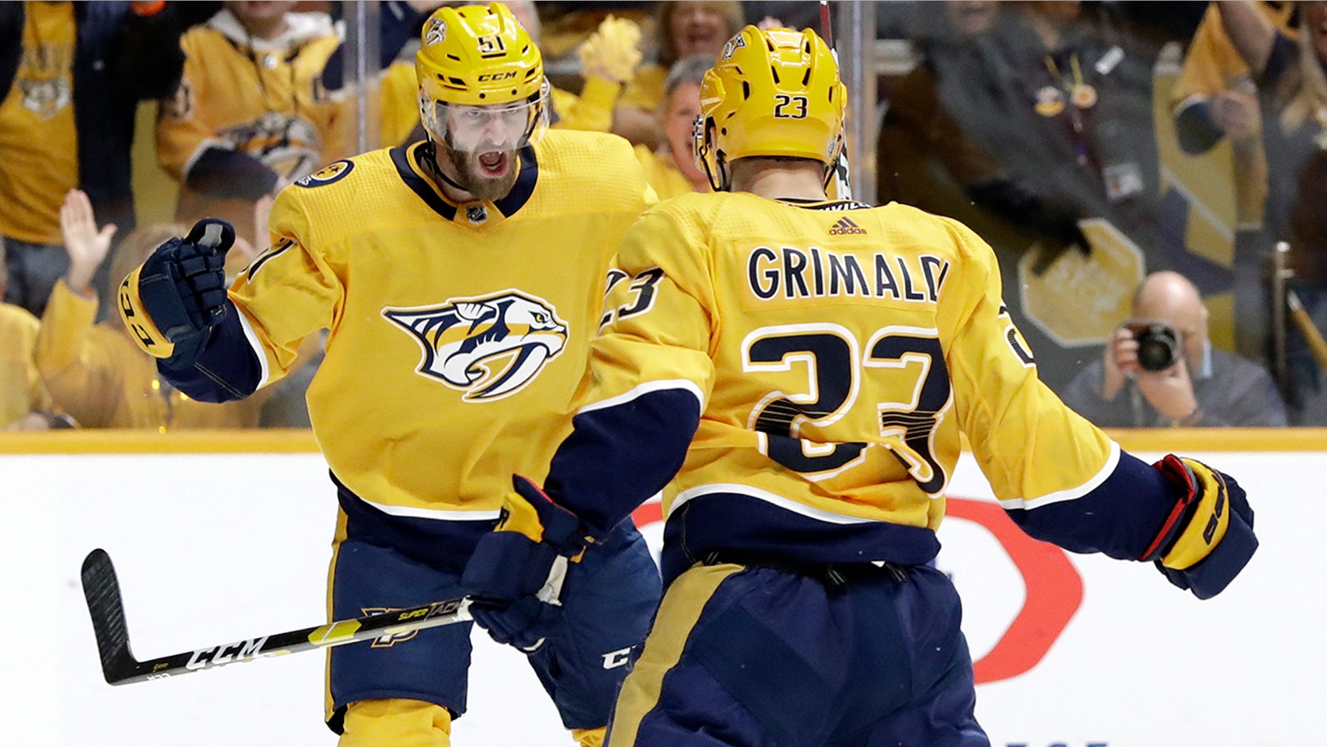 Nashville Predators center Rocco Grimaldi (23) celebrates with Austin Watson (51) after scoring a goal against the Dallas Stars during the second period in Game 2 of an NHL hockey first-round playoff series Saturday, April 13, 2019, in Nashville, Tenn. (AP Photo/Mark Humphrey)