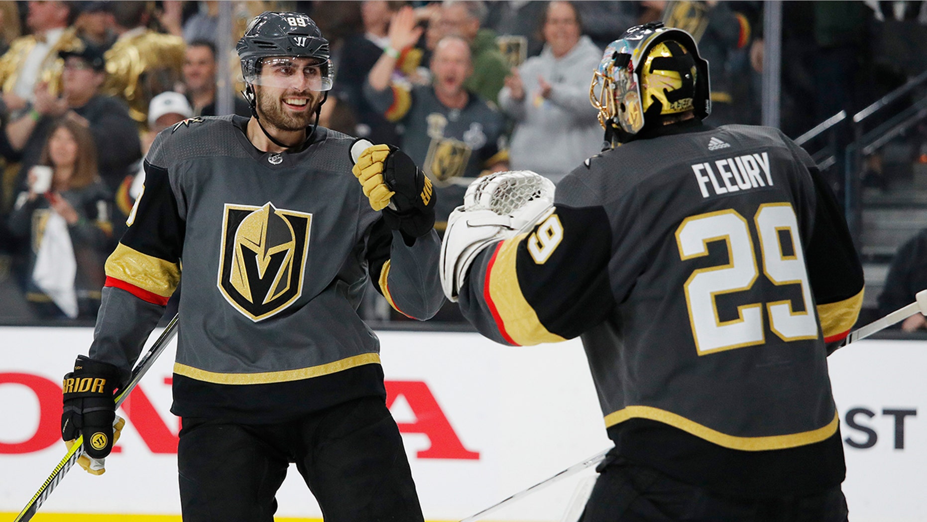 Vegas Golden Knights right wing Alex Tuch, left, celebrates with goalie Marc-Andre Fleury after scoring against the San Jose Sharks during the third period of Game 4 of a first-round NHL hockey playoff series Tuesday, April 16, 2019, in Las Vegas. (AP Photo/John Locher)