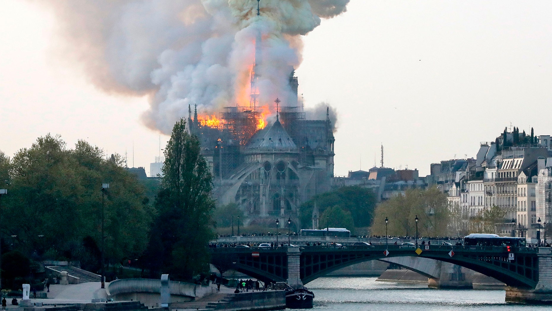Smoke ascends as flames rise during a fire at the landmark Notre-Dame Cathedral in central Paris on April 15, 2019 afternoon, potentially involving renovation works being carried out at the site, the fire service said.