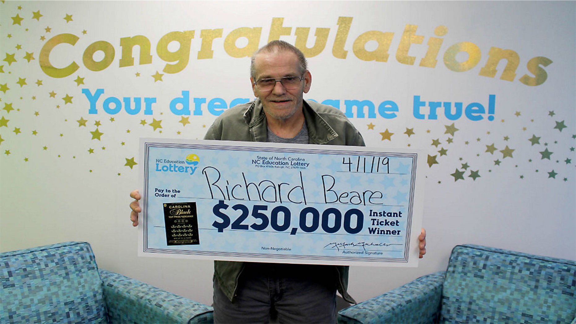Richard Beare collected his big prize from the winning scratch-off ticket Monday.