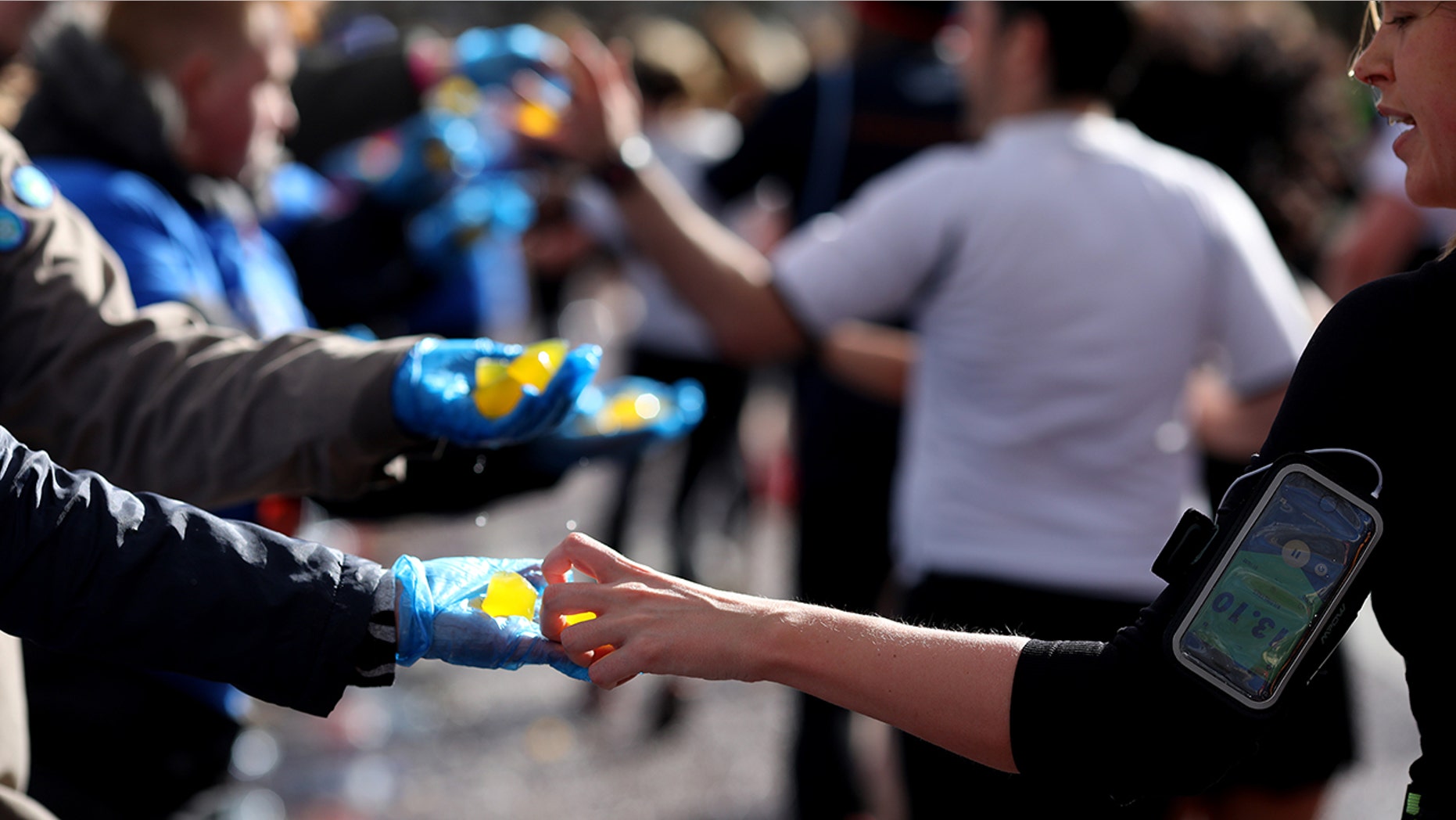 Competitors grab edible seaweed capsules during the Vitality Big Half on March 10 in London. (Photo by Charlie Crowhurst/Getty Images for Lucozade Sport)