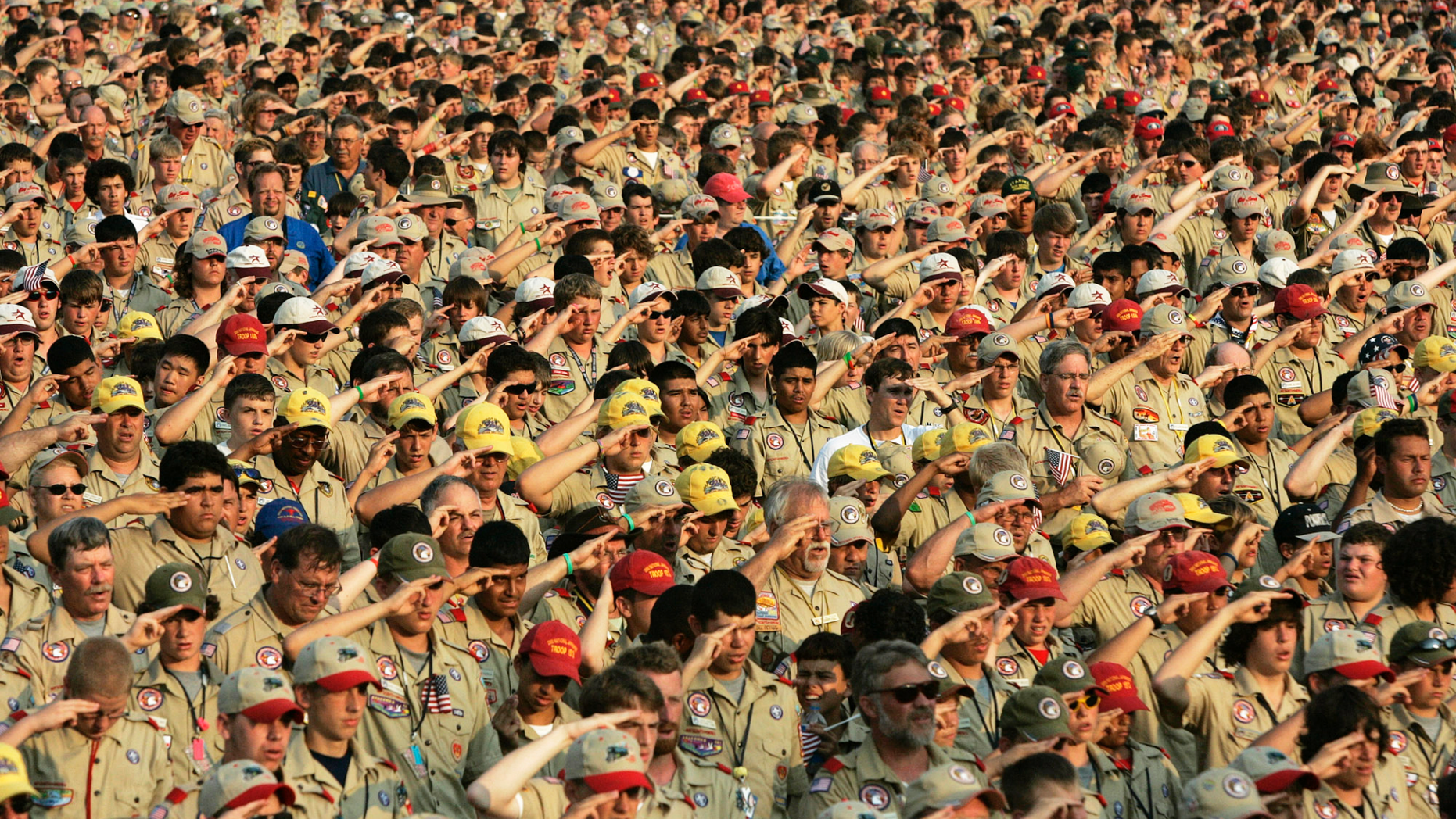 FILE - In this July 31, 2005 file photo, Boy Scouts salute as they recite the Pledge of Allegiance during the Boy Scout Jamboree in Bowling Green, Va. In 2019, financial threats to the Boy Scouts have intensified as multiple states consider adjusting their statute-of-limitations laws so that victims of long-ago child sex-abuse have a chance to seek redress in the courts. (AP Photo/ Haraz N. Ghanbari)