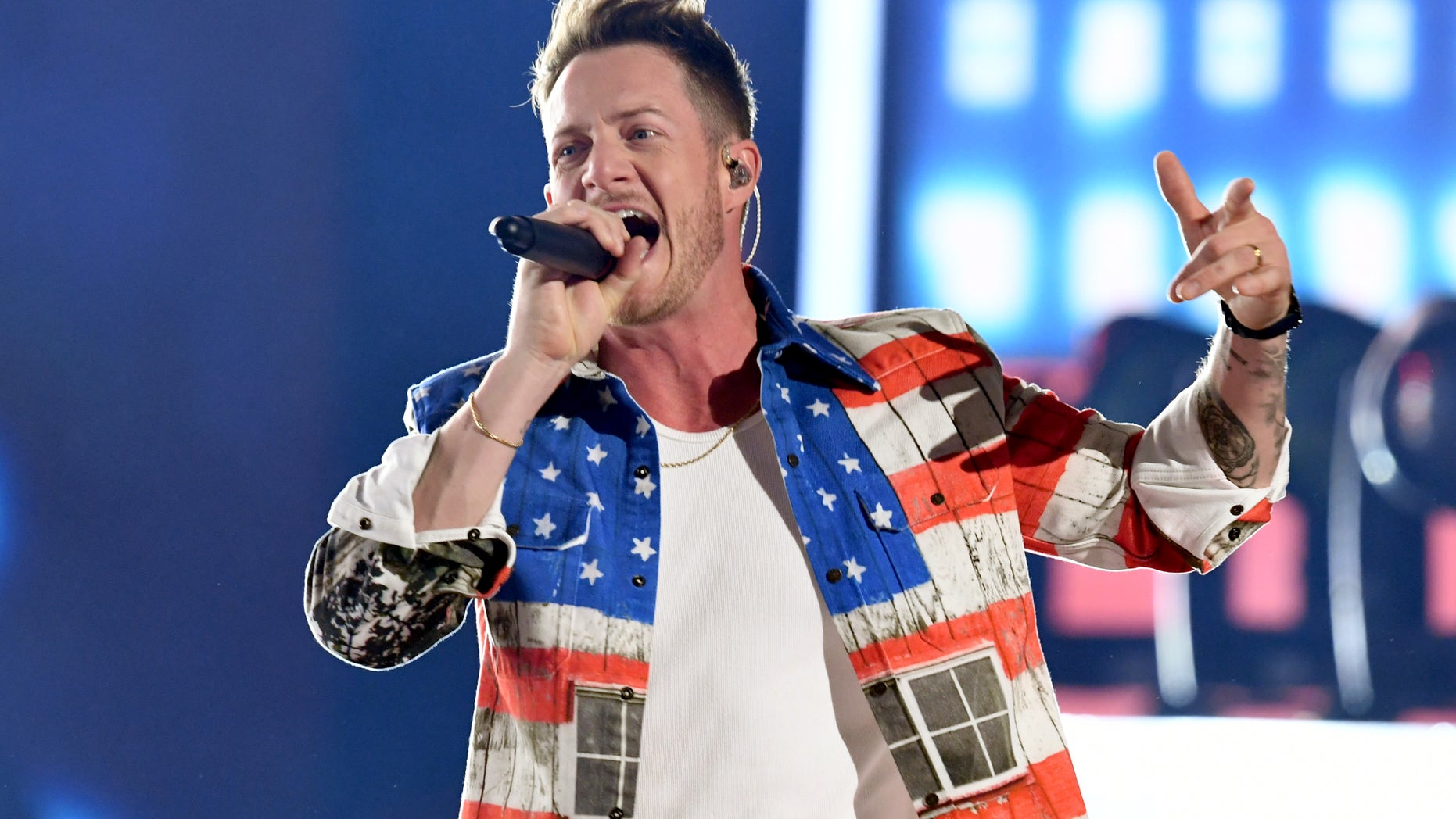 Florida Georgia Line's Tyler Hubbard, wearing an American flag jacket and jeans, performs at the 2019 ACM Awards in Las Vegas.