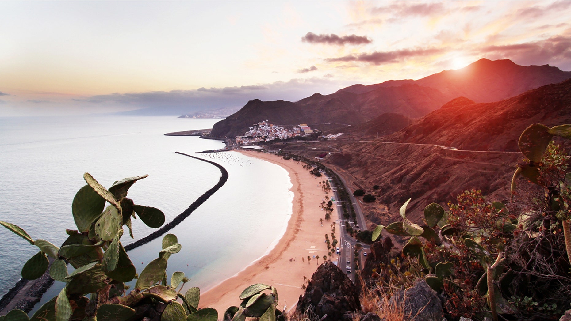 View of Playa de Las Teresitas, Sant Andres and Santa Cruz de Tenerife at sunset.