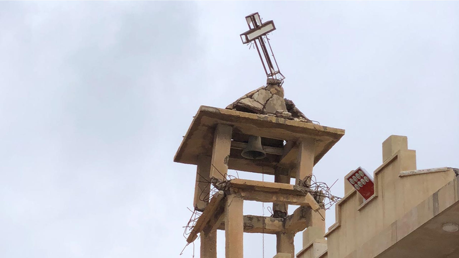The bell tower of St. Adday Church in Karamles, a town the Knights of Columbus helped rebuild. The crooked cross is still standing despite the demotion of ISIS in the region.