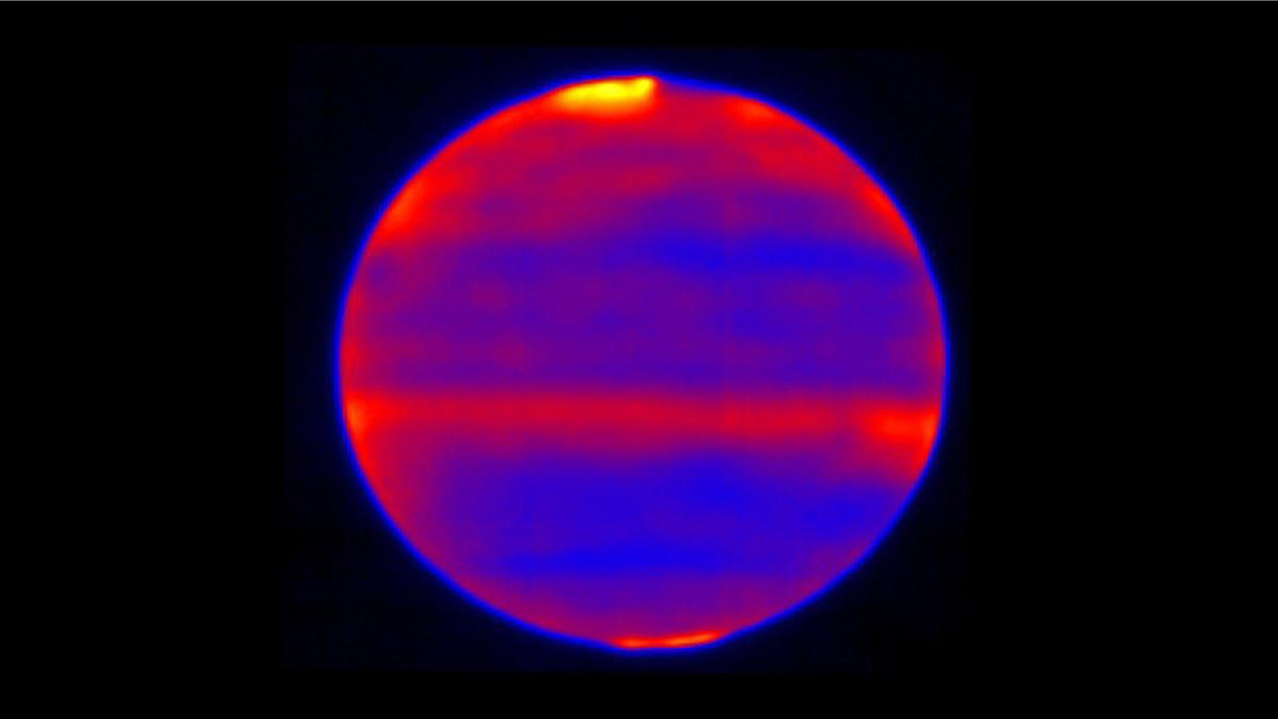 Scientists used red, blue and yellow to infuse this infrared image of Jupiter's atmosphere (red and yellow indicate the hotter regions), which was recorded by the Cooled Mid-Infrared Camera and Spectrograph (COMICS) at the Subaru Telescope on the summit of Mauna Kea, Hawaii on Jan. 12, 2017. (Credit: NAOJ and NASA/JPL-Caltech)