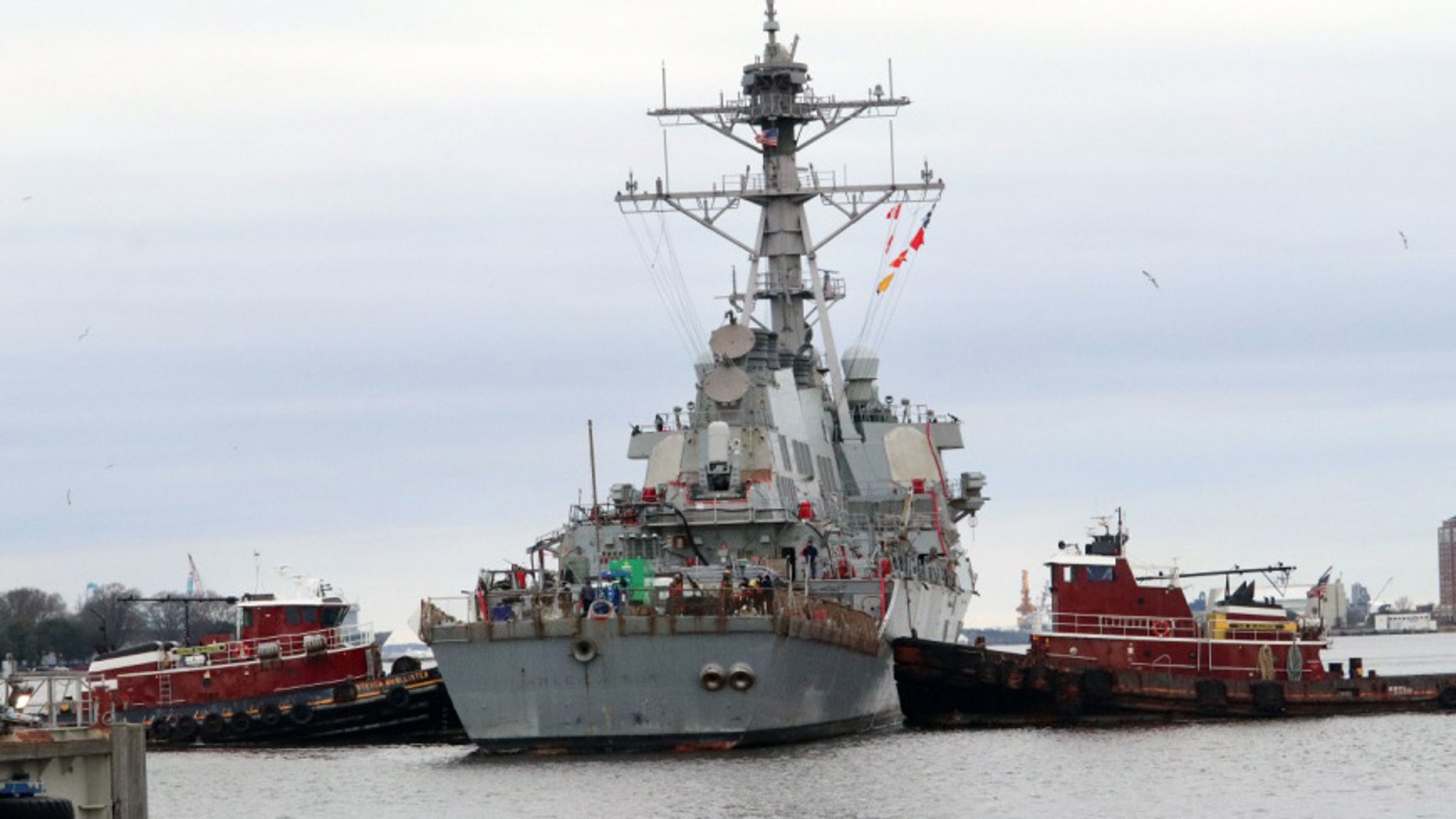 Tugboats maneuver the guided-missile destroyer USS Arleigh Burke (DDG 51) in position for dry-docking in preparation for the ship’s Extended Dry-Docking Selected Restricted Availability (EDSRA).