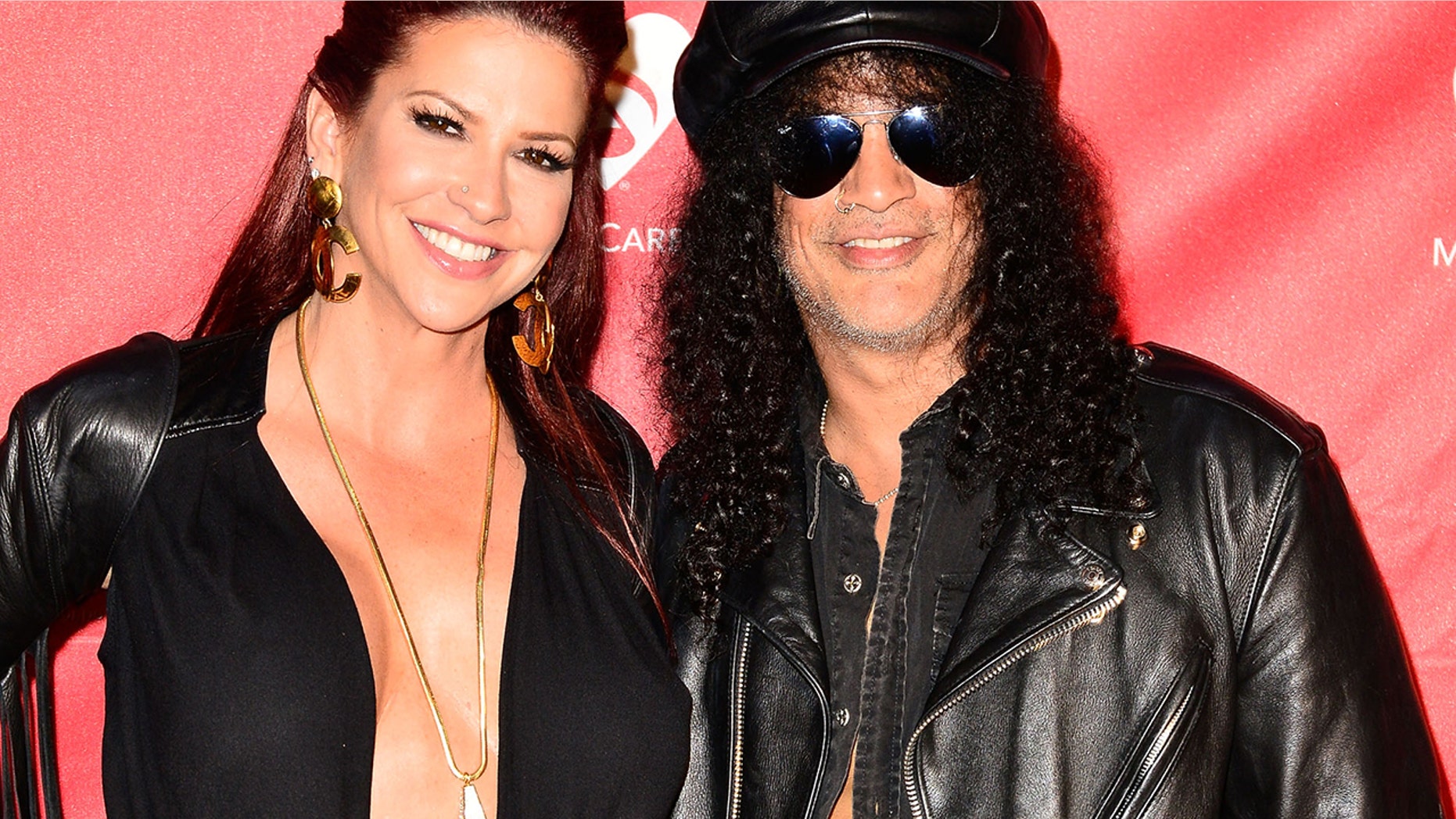 Musician Slash, right, and now-ex-wife Perla Hudson arrive at the MusiCares MAP Fund Benefit Concert at Club Nokia on May 12, 2014 in Los Angeles.