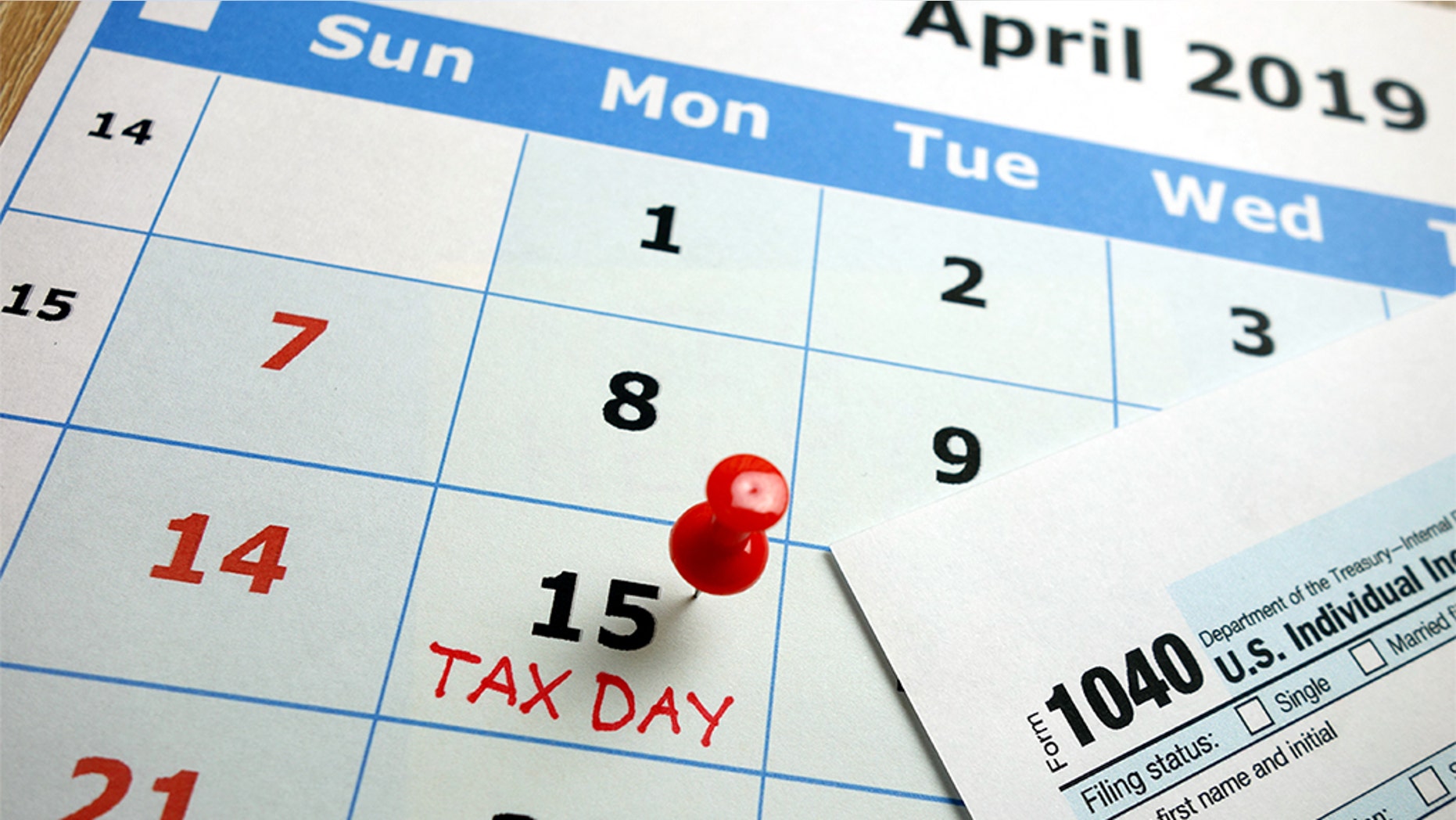Tax day marked on April 2019 monthly calendar with 1040 form