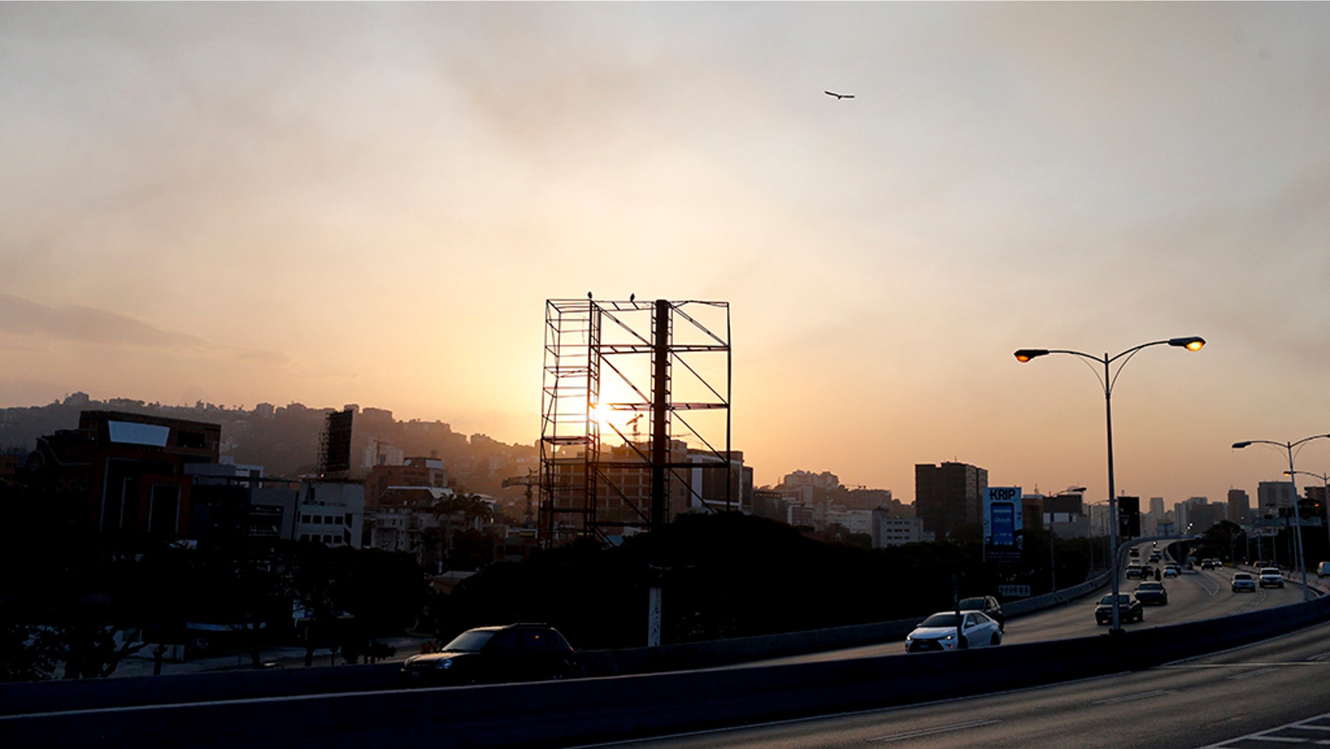 A billboard stands empty above a highway with no traffic as the sun sets in Caracas, Venezuela, Monday, March 18, 2019. When the sun goes down in Venezuela's capital, the once-thriving metropolis empties under darkness. (AP Photo/Natacha Pisarenko)