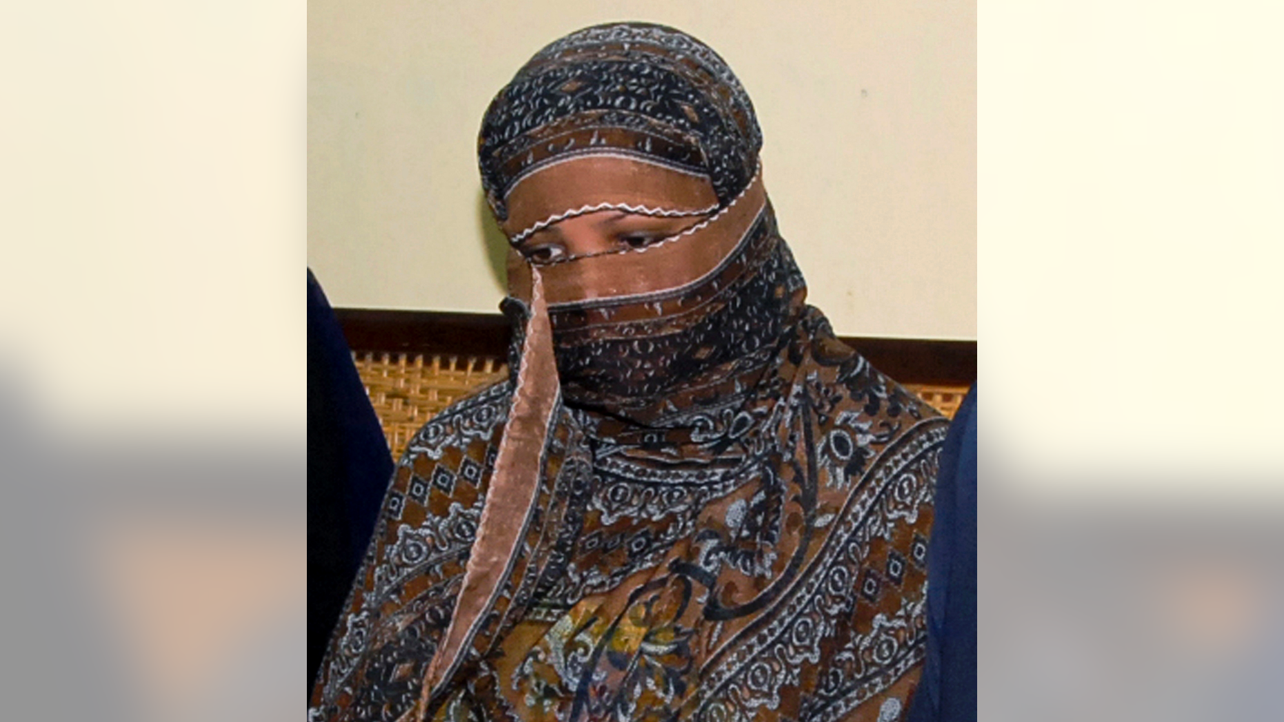 FILE - In this Nov. 20, 2010, file photo, Aasia Bibi, a Pakistani Christian woman, listens to officials at a prison in Sheikhupura near Lahore, Pakistan. Pakistani media say Aasia Bibi, a Christian woman acquitted of blasphemy after spending eight years on death row, has left Pakistan for Canada to be reunited with her daughters. Wilson Chawdhry of the British Pakistani Christian Association told The Associated Press on Wednesday, May 8, 2019, he received a telephone text message from a British diplomat stating simply that “Aasia is out.” (AP Photo, File)