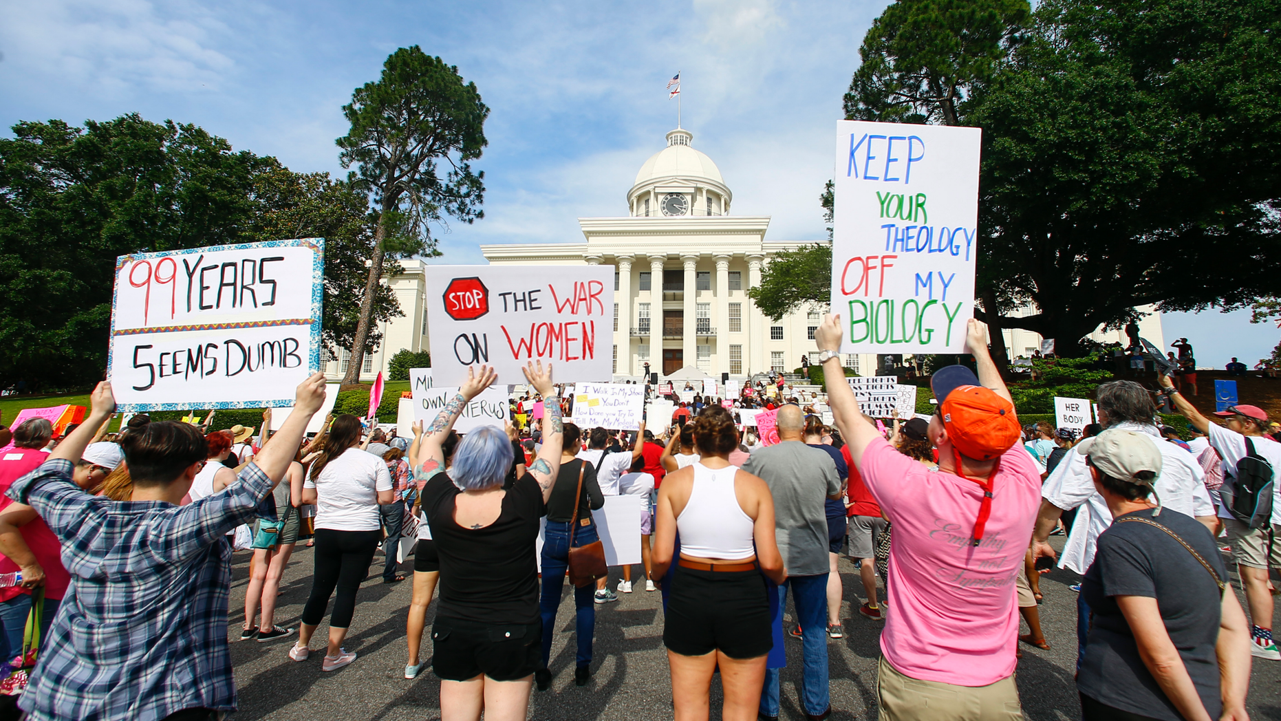 Protesters for women's rights hold a rally on the Alabama Capitol steps to protest a law passed last week making abortion a felony in nearly all cases with no exceptions for cases of rape or incest, Sunday, May 19, 2019, in Montgomery, Ala. (AP Photo/Butch Dill)