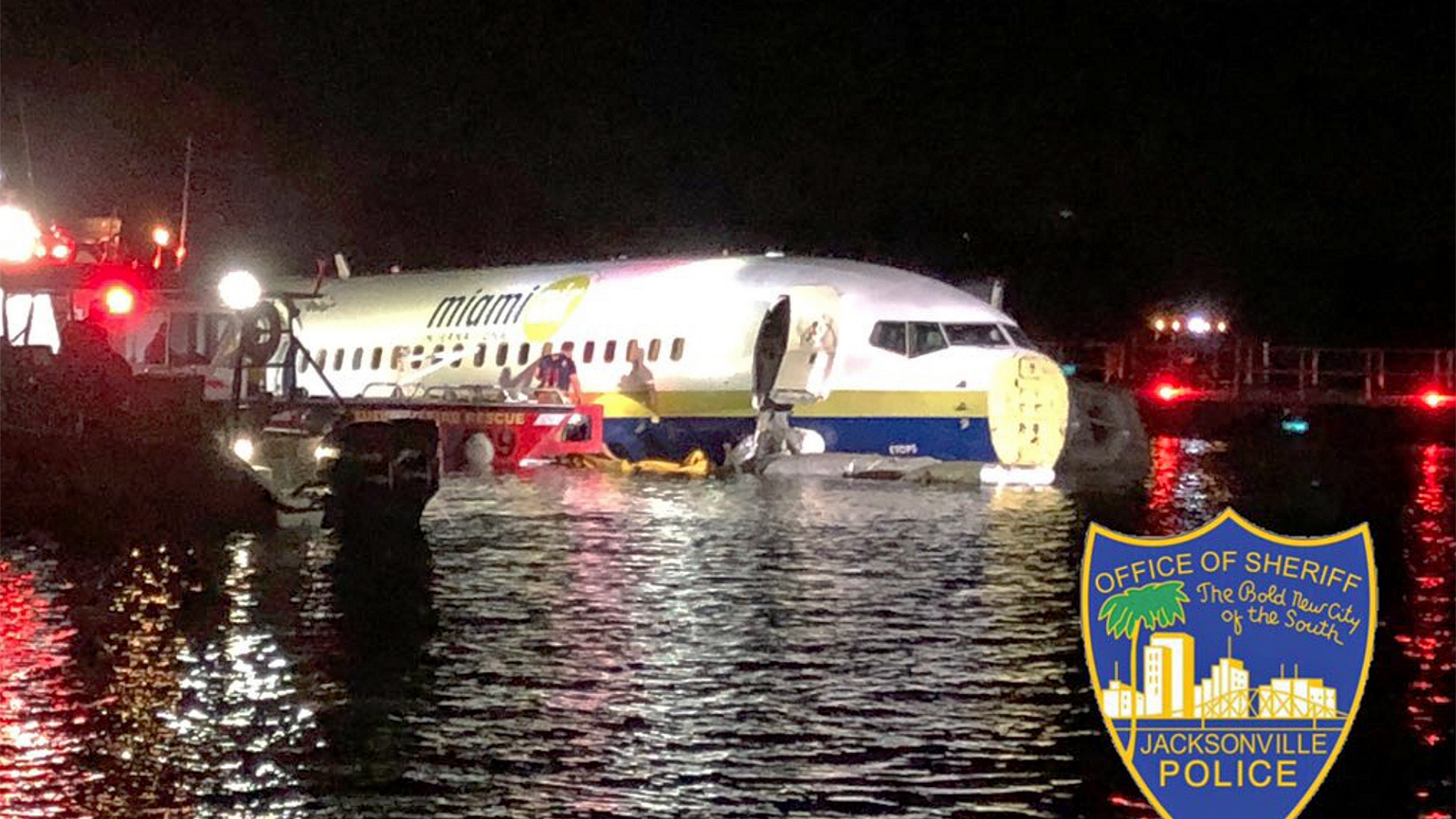 In this photo released by the Jacksonville Sheriff's Office, authorities work at the scene of a plane in the water in Jacksonville, Fla., Friday, May 3, 2019. Officials say a charter plane traveling from Cuba to north Florida ended up in a river at the end of a runway. A Naval Air Station Jacksonville news release says a Boeing 737 arriving from Naval Station Guantanamo Bay, Cuba, crashed into the St. Johns River Friday night. (Jacksonville Sheriff's Office via AP)