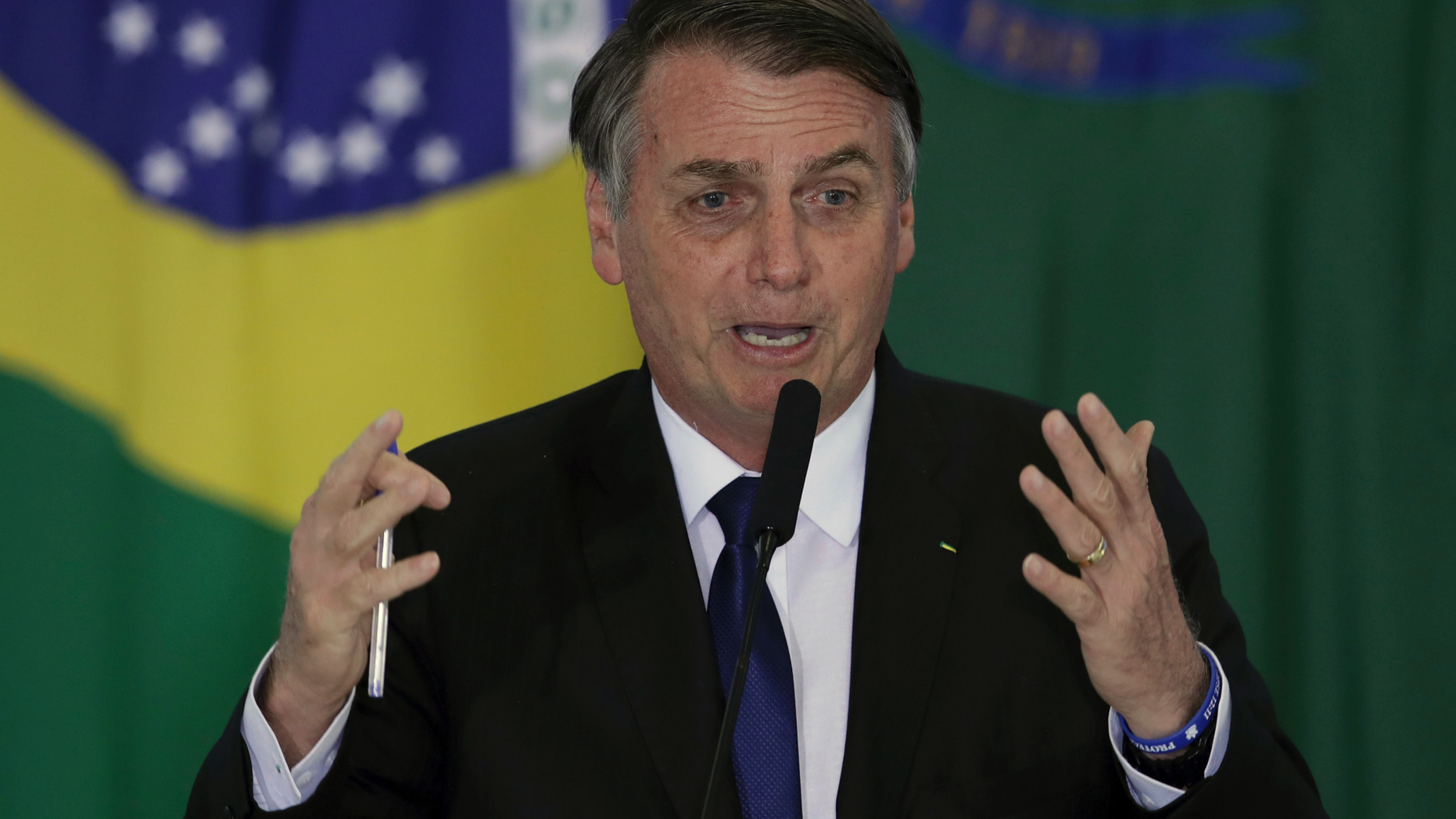 Brazil's President Jair Bolsonaro speaks during a ceremony where he signed a second decree that eases gun restrictions, during the signing ceremony at Planalto presidential palace in Brasilia, Brazil, Tuesday, May 7, 2019. The decree opens Brazil’s market to guns and ammunition made outside of Brazil according to a summary of the decree. Gun owners can now buy between 1,000 -5,000 rounds of ammunition per year depending on their license, up from 50 rounds. Lower-ranking military members can now carry guns after 10 years of service. (AP Photo/Eraldo Peres)