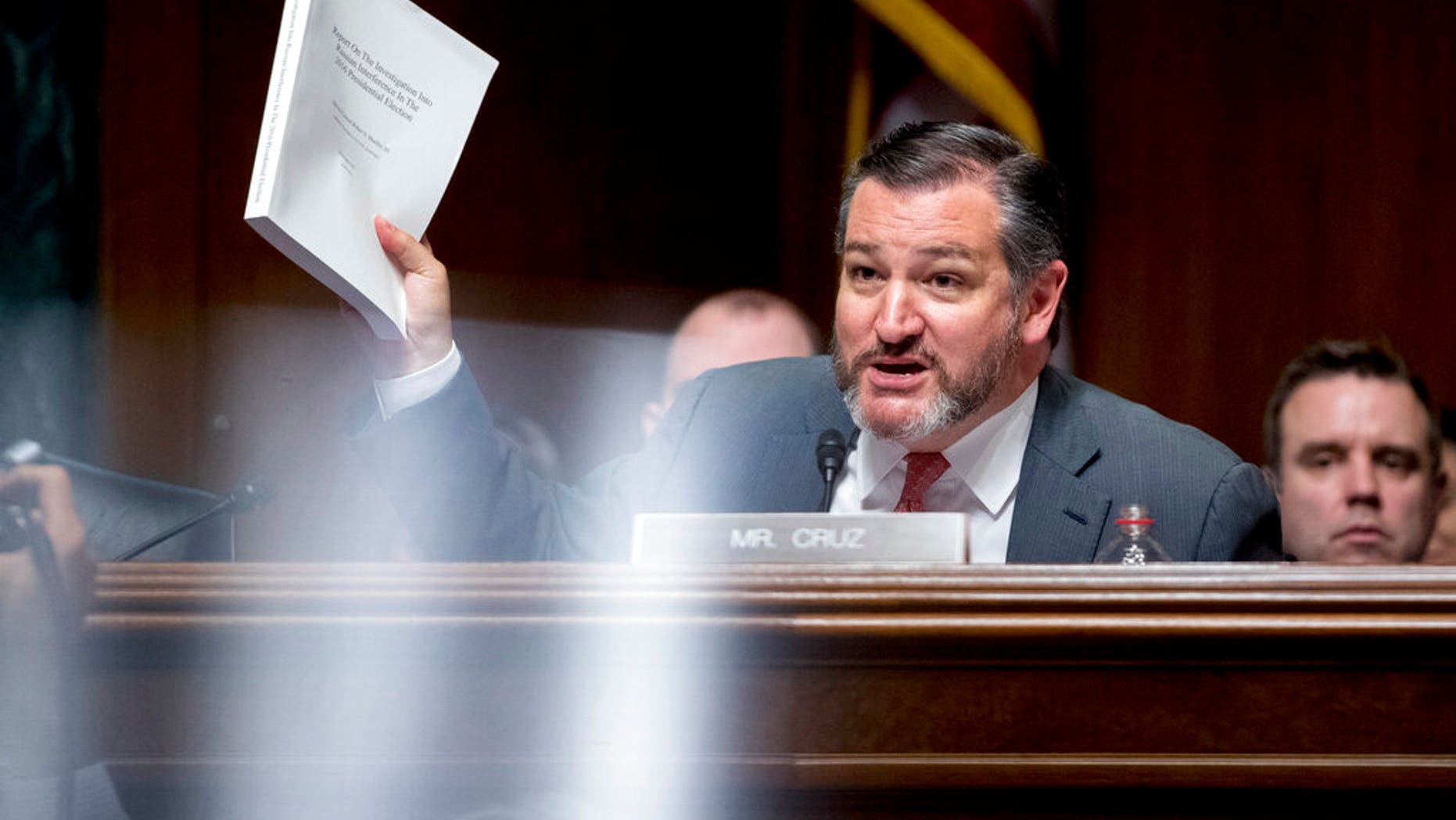Sen. Ted Cruz, R-Texas, holds up a copy of the Mueller report as he questions Attorney General William Barr during a Senate Judiciary Committee hearing on Capitol Hill in Washington.