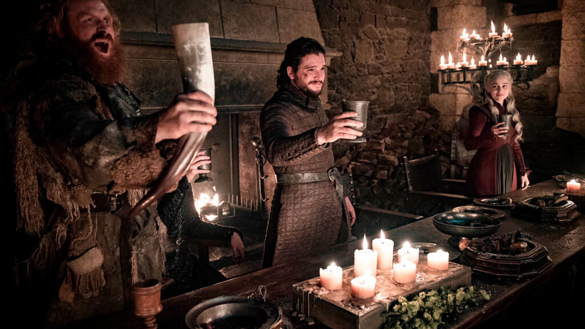 This image released by HBO shows Kristofer Hivju, from left, Kit Harington and Emilia Clarke in a scene from "Game of Thrones."
