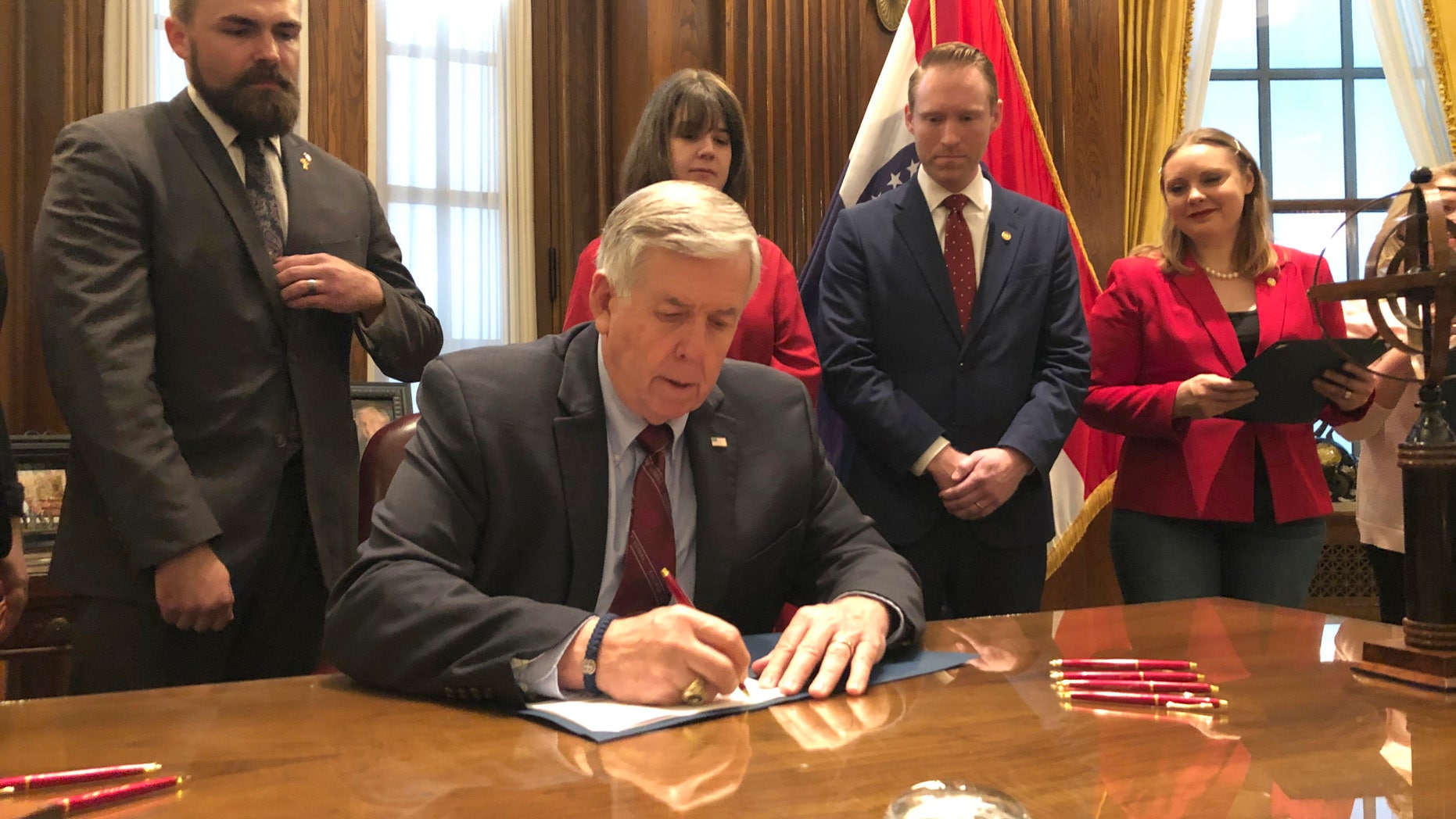 Missouri Gov. Mike Parson signs one of the nation's most restrictive abortion bills, banning the procedure on or beyond eight weeks of pregnancy, Friday, May 24, 2019 in Jefferson City, Mo. (AP Photo by Summer Balentine)