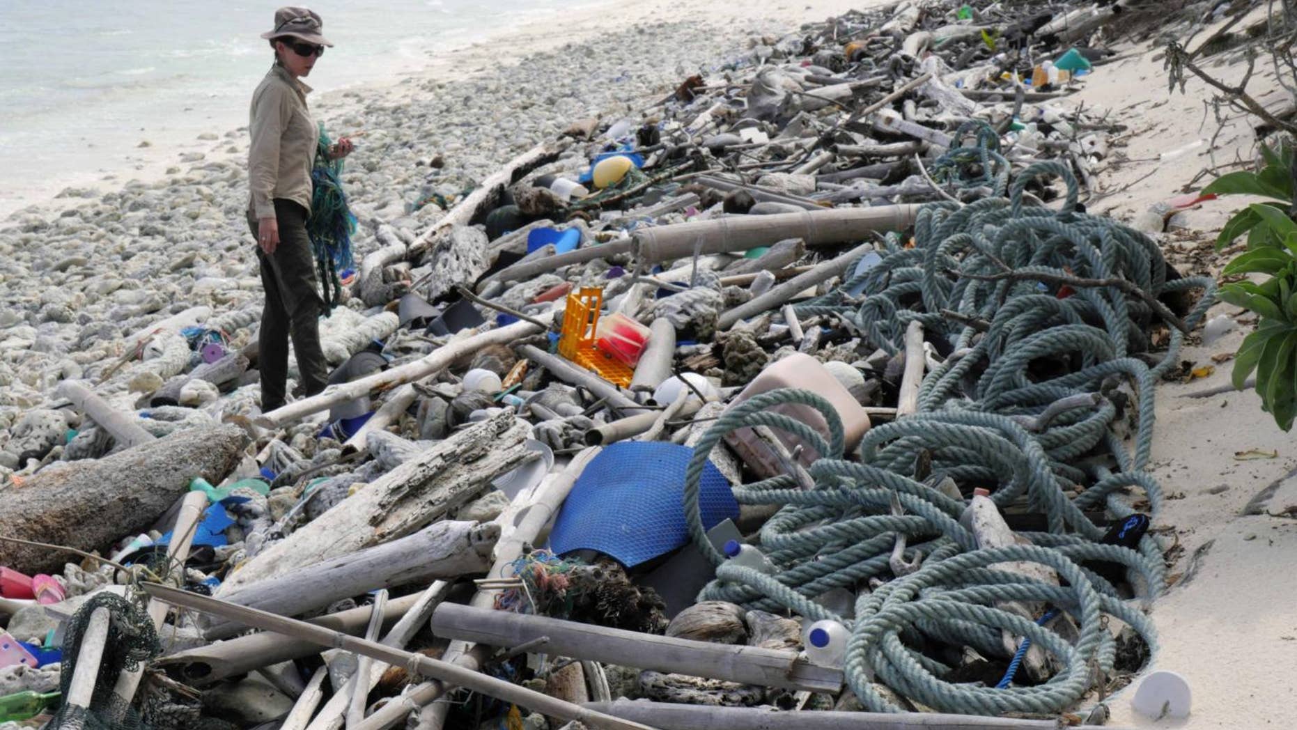 Lead author Jennifer Lavers looks out at the plastic debris covering a Cocos (Keeling) Island beach.
