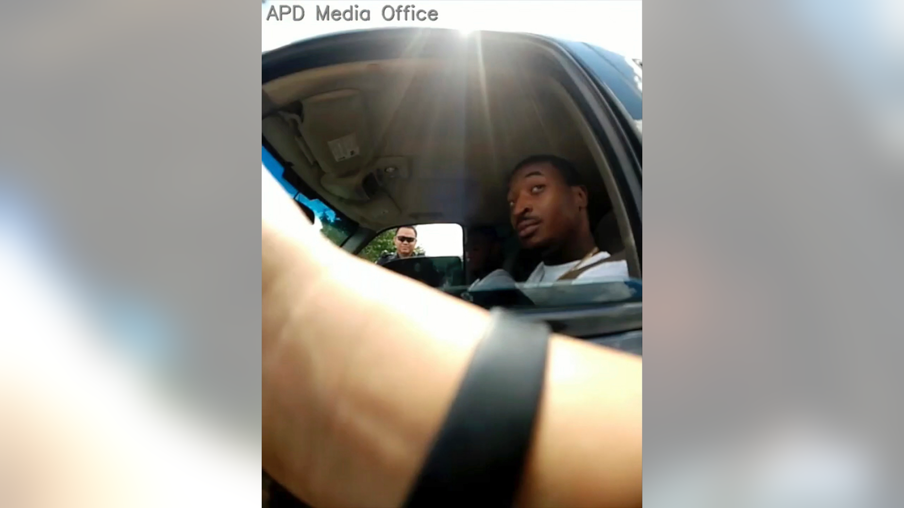 In this screenshot taken from Sept. 1, 2018, police body camera video provided by the Arlington Police Department, an officer, foreground, talks to O'Shae Terry after stopping him for a vehicle registration violation, in Arlington, Texas, as a second officer, background left, looks in from the passenger side window. Bau Tran, a Texas police officer has been fired after he was charged with criminally negligent homicide in the fatal shooting of a black man during a traffic stop last year. In a statement Friday, May 17, 2019 Arlington police announced Officer Bau Tran was fired after an internal investigation found policy violations that led to the Sept. 1 shooting of 24-year-old O’Shae Terry. (Arlington Police Department via AP, File)