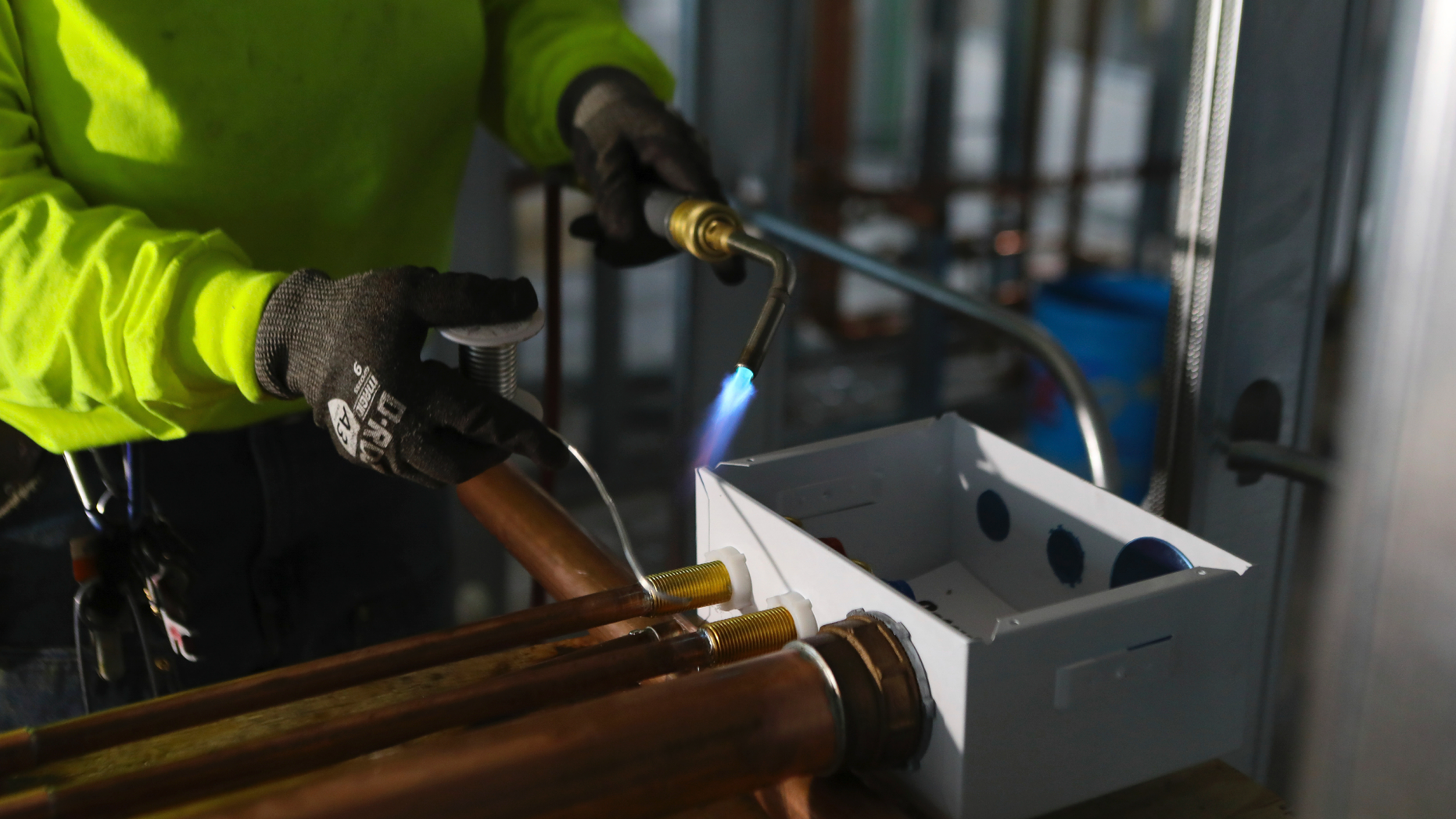 FILE- In this Jan. 24, 2019, file photo, Zakiyyah Askia, a plumbing apprentice in a program run by the nonprofit Chicago Women in Trades, welds pipes at a high rise residence under construction in Chicago. On Friday, May 3, the Institute for Supply Management, a trade group of purchasing managers, issues its index of non-manufacturing activity for April. (AP Photo/Teresa Crawford, File)