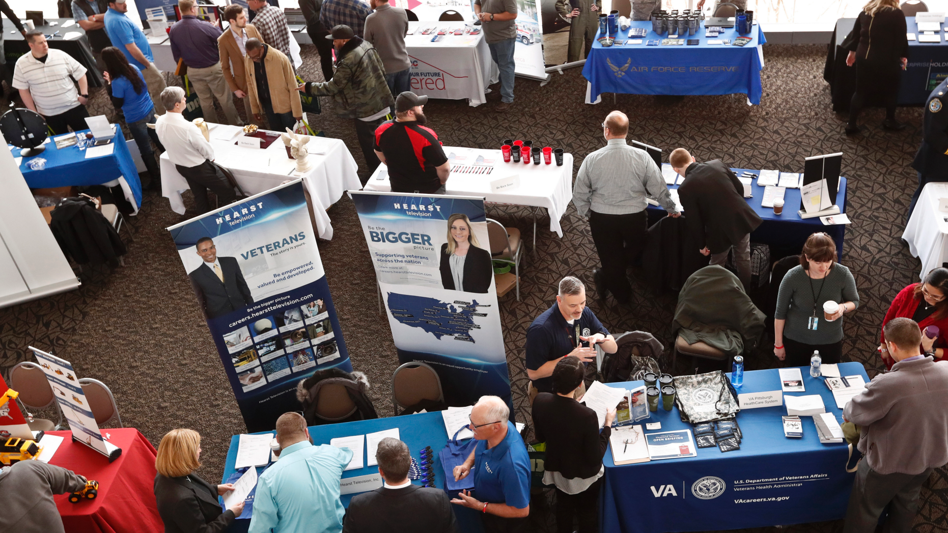 FILE - In this March 7, 2019, photo visitors to the Pittsburgh veterans job fair meet with recruiters at Heinz Field in Pittsburgh. On Friday, May 3, the U.S. government issues the April jobs report. (AP Photo/Keith Srakocic, File)