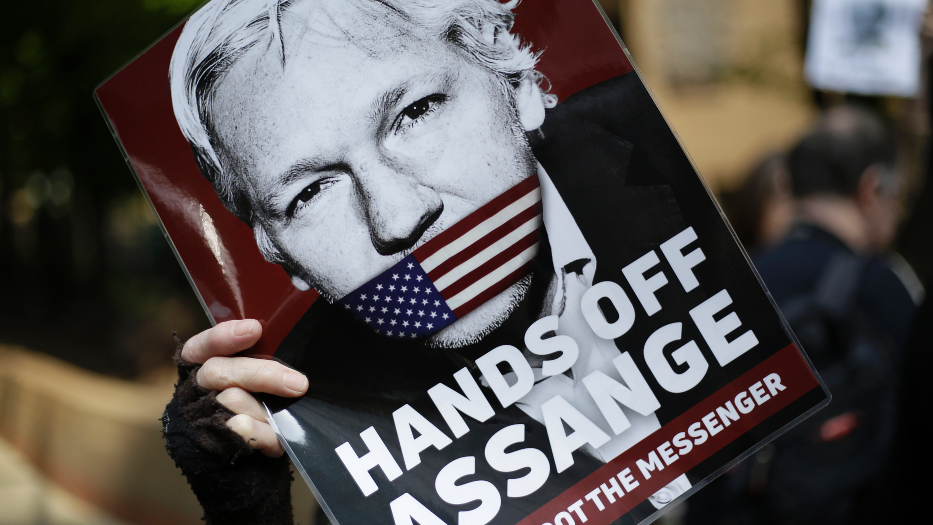 FILE - In this May 1, 2019, file photo, protesters demonstrate outside court where Julian Assange will appear in London. The Justice Department has charged Assange with receiving and publishing classified information. The charges are contained in a new, 18-count indictment announced May 23, 2019. (AP Photo/Matt Dunham, File)